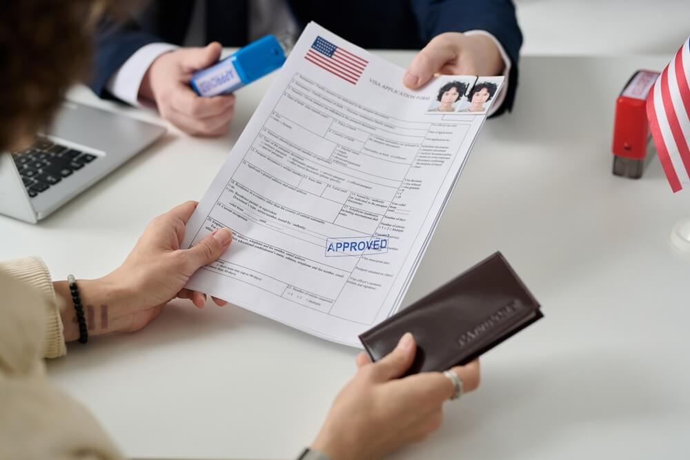 Handing visa application across a desk