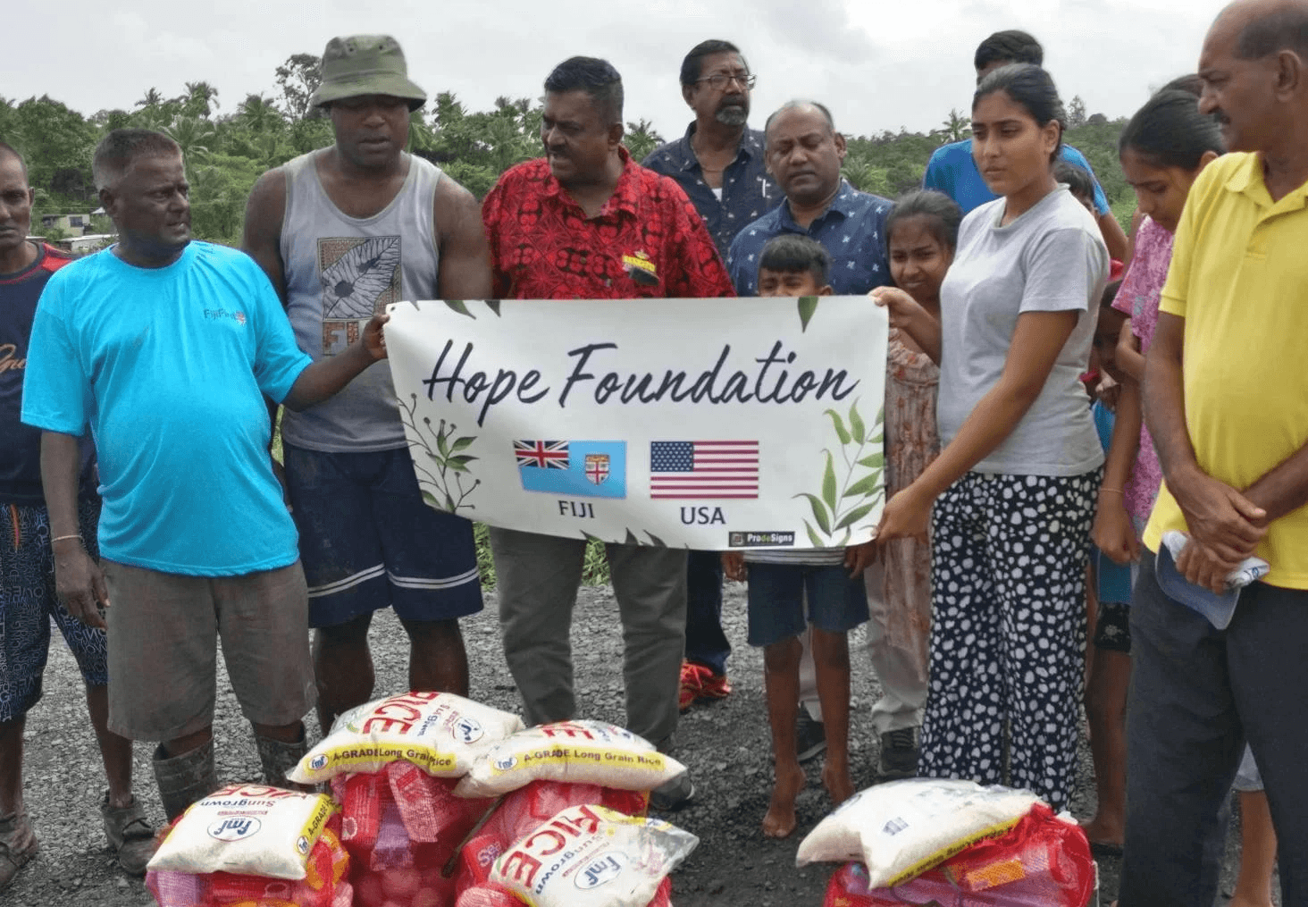 five children smiling while doing peace hand sign