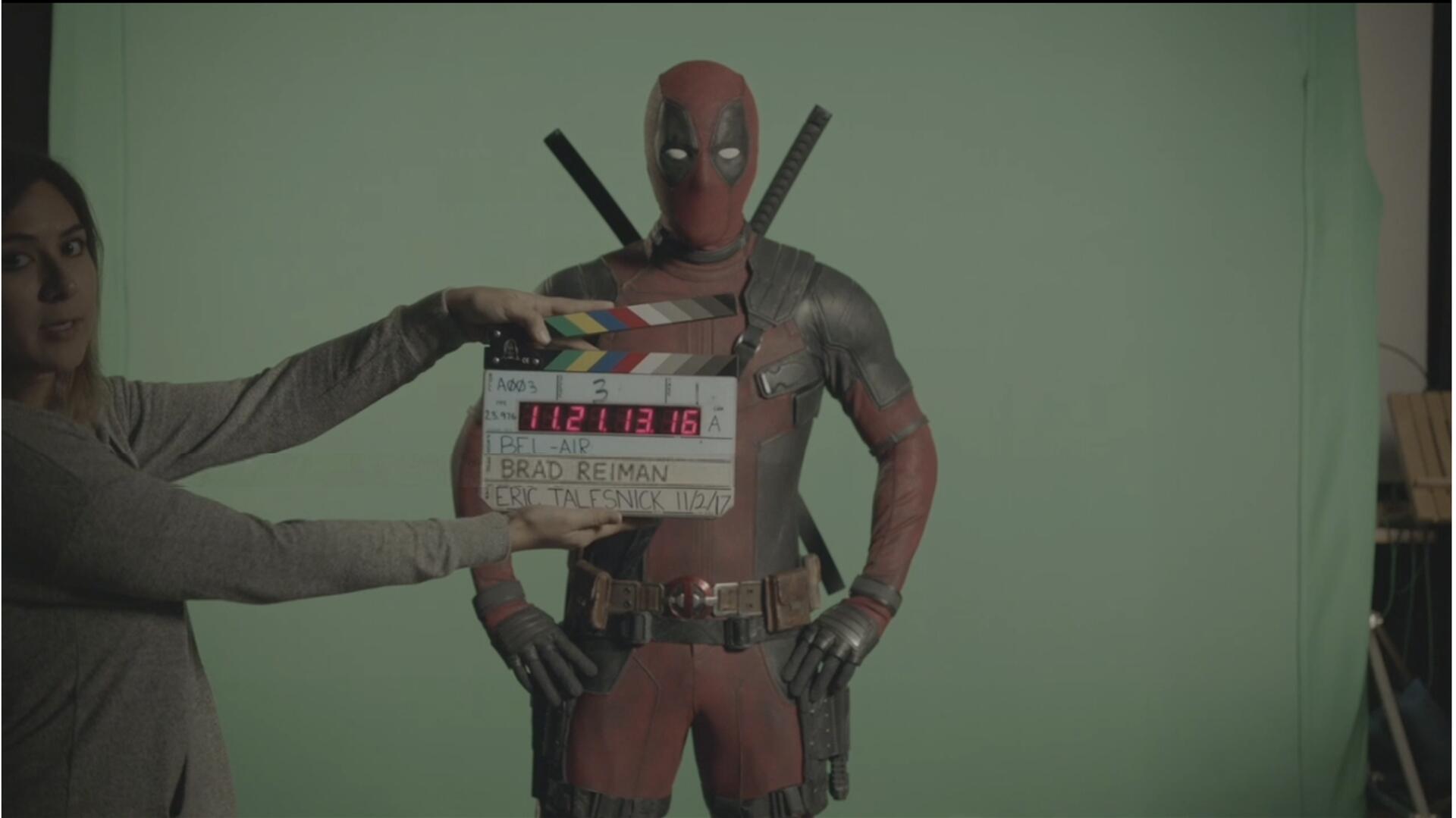 Deadpool on set with a clapperboard