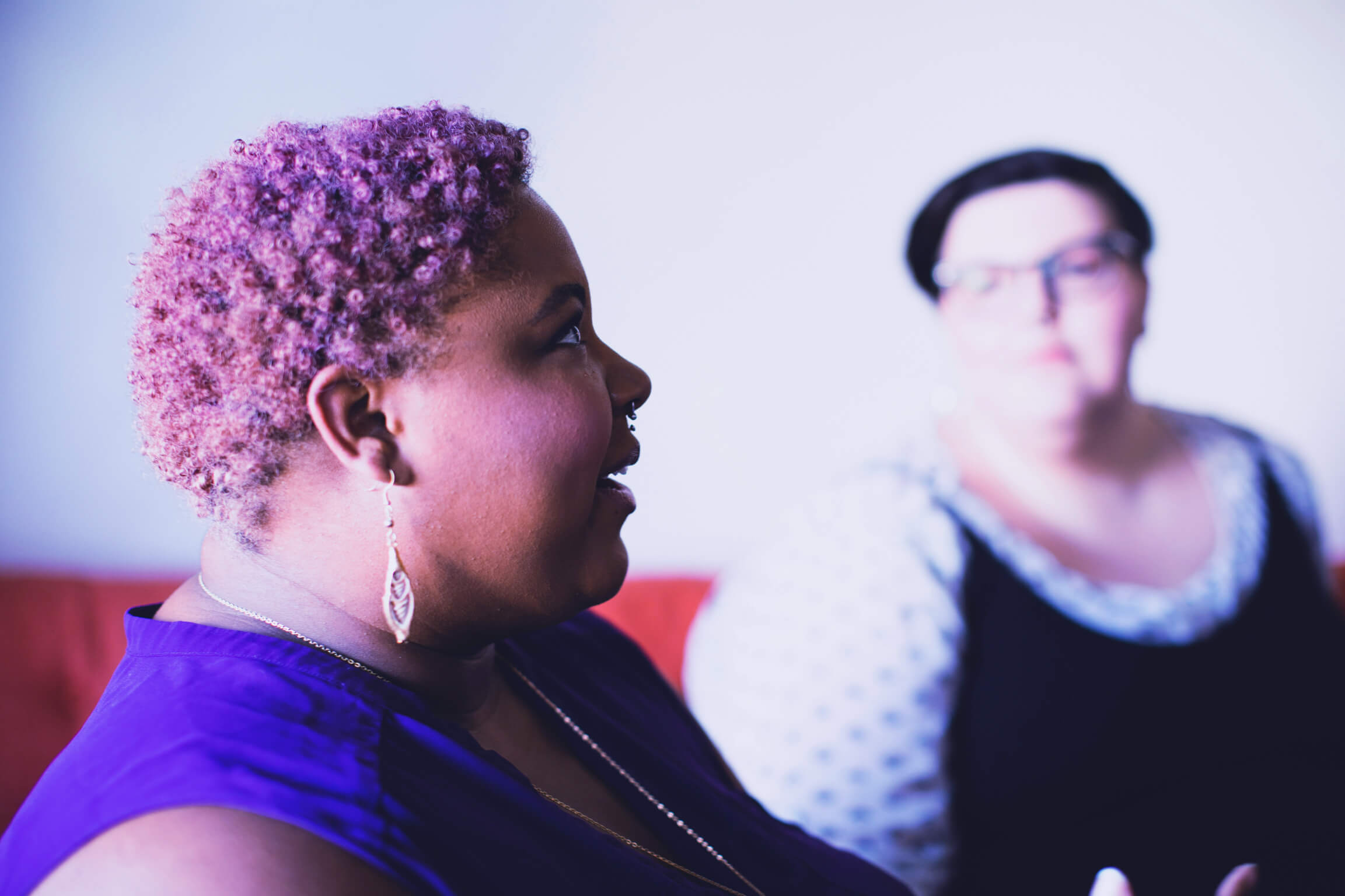 Weight loss two women sitting on red couch