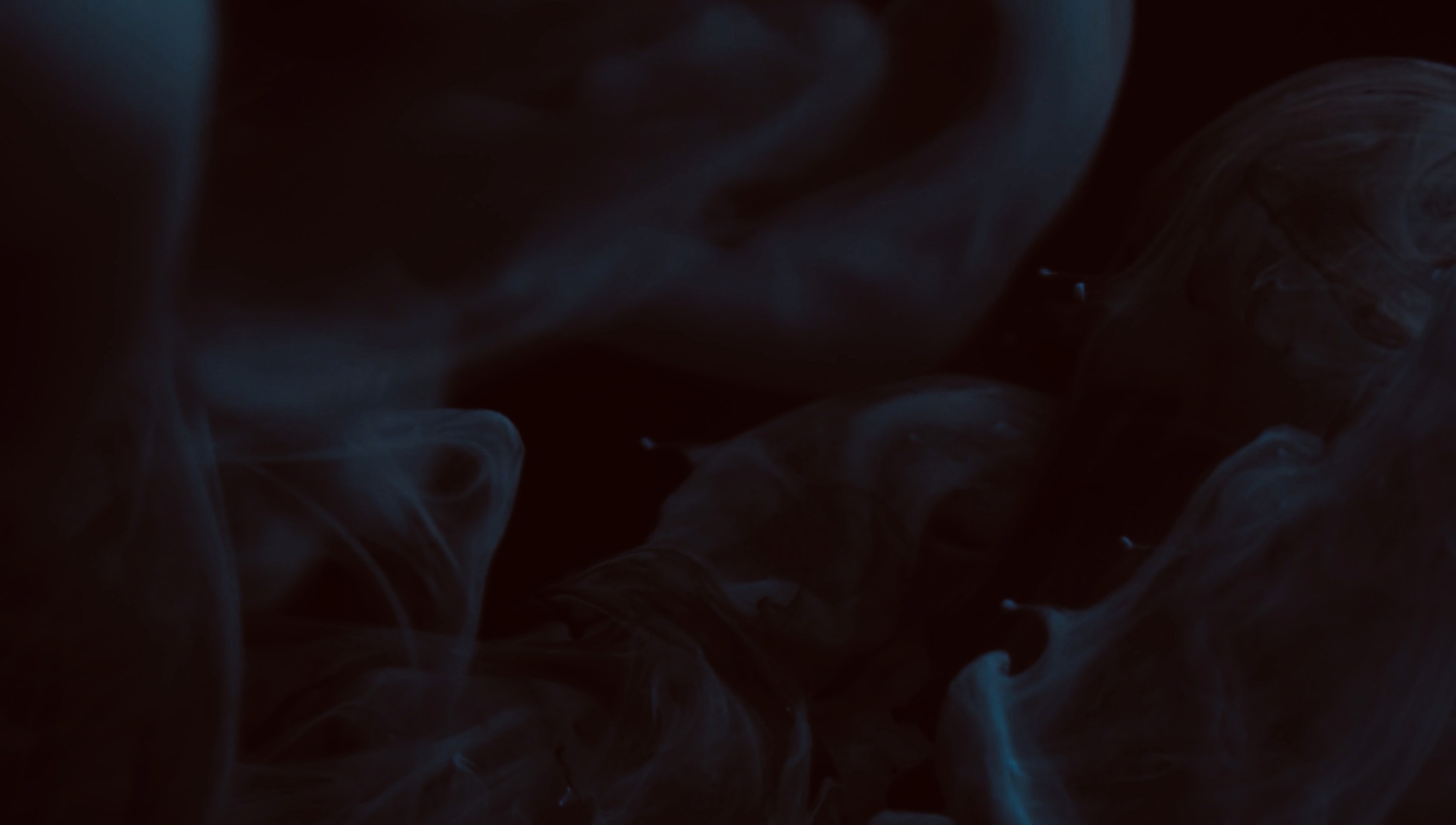 Minimalist passageway with tall curved rust-colored metal walls and dramatic sunlight shadows.