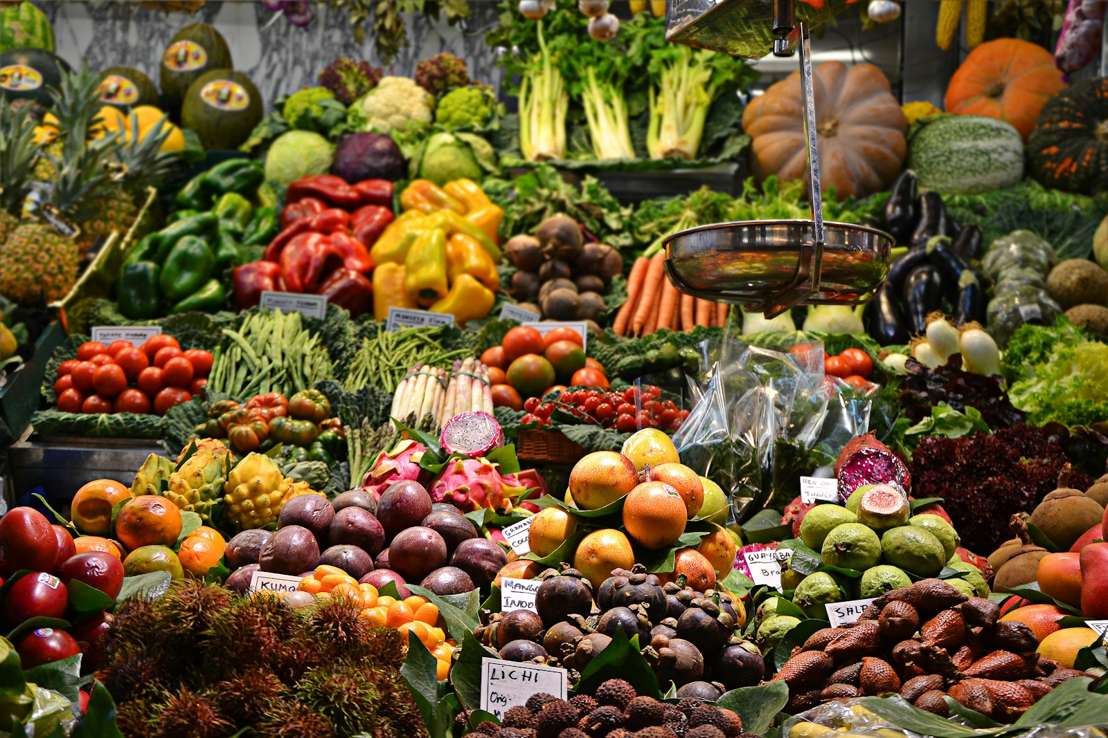 An abundant market display of assorted fresh fruits and vegetables, illustrating the microbial diversity a varied diet helps support