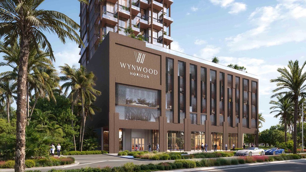Wynwood Horizon tower surrounded by lush trees and reflective water, creating a serene natural landscape.