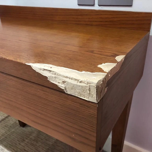 Scratched solid wood dining table before repair in Dubai