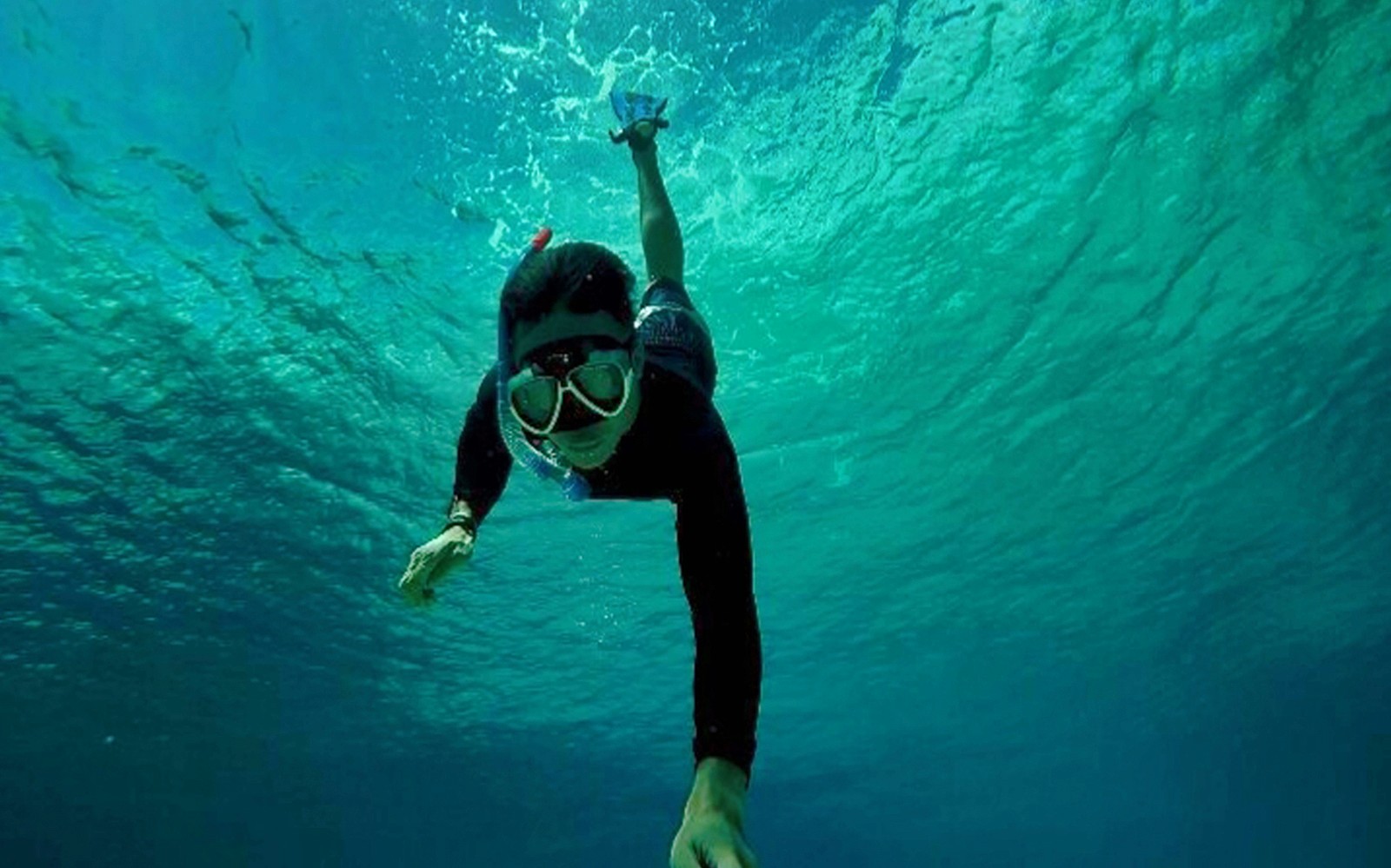 Snorkeler exploring underwater at Blue Lagoon, Bali.