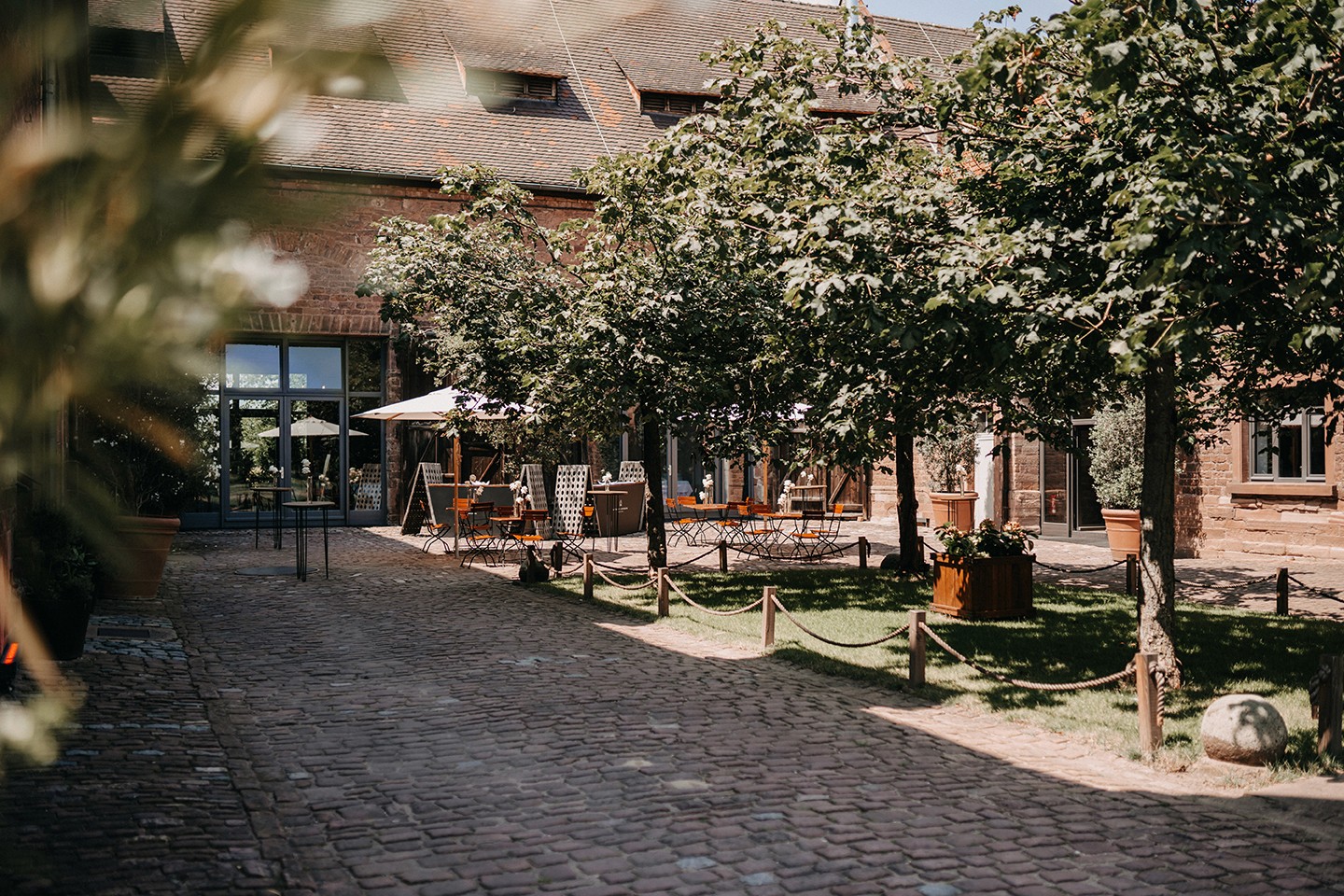 Person balancing on rocks by the ocean at sunset