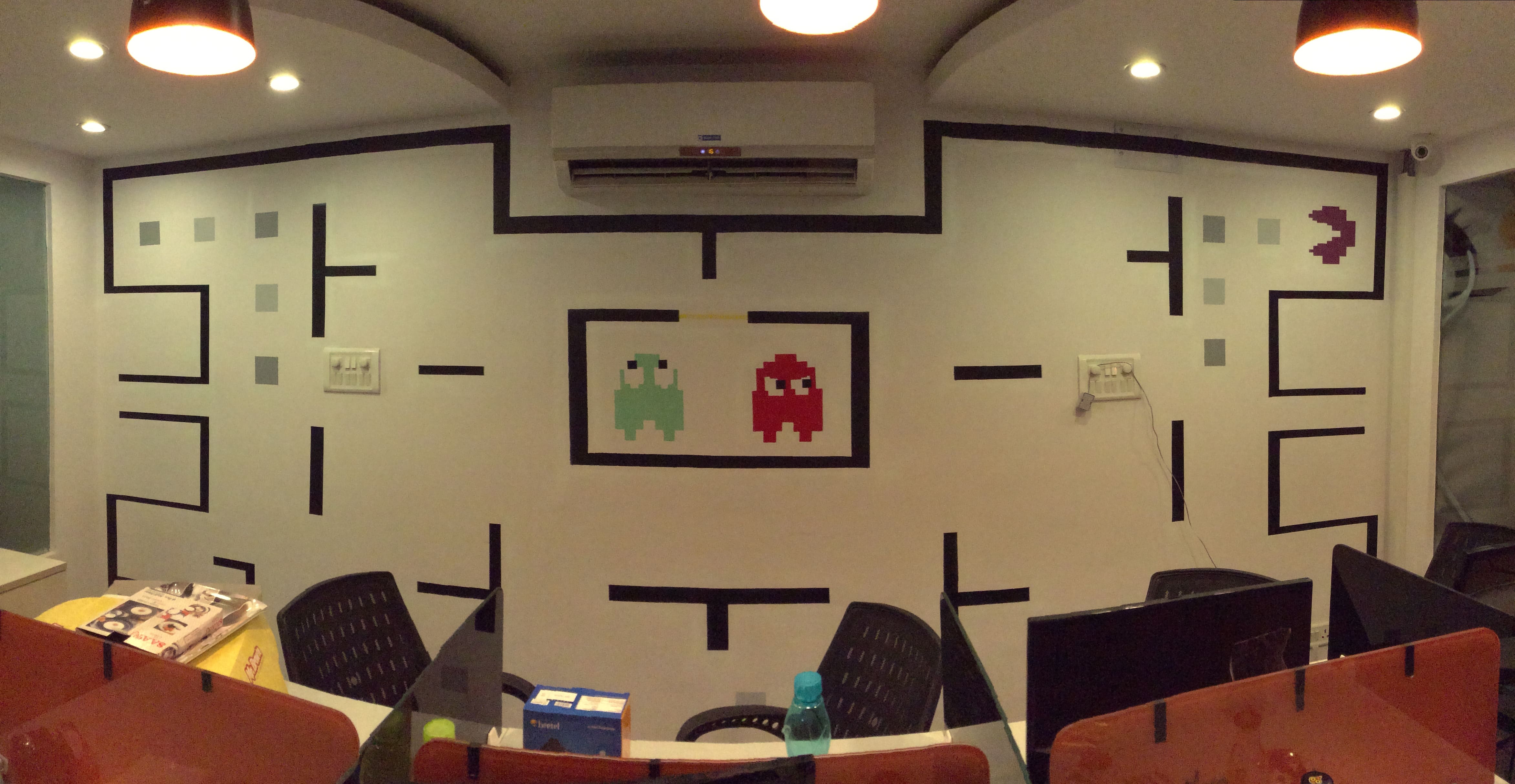 Commissioned mural painting of the classic game Pacman for a commercial space in Delhi.