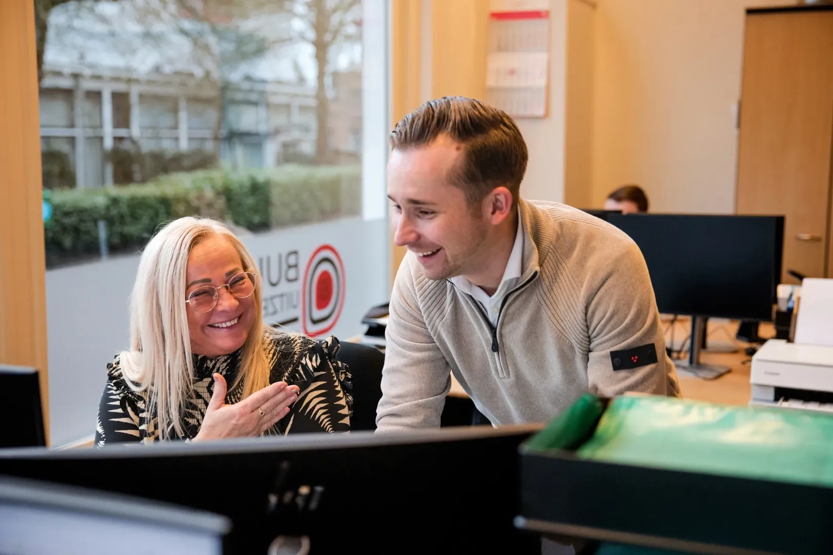 man in green and black plaid long sleeve shirt holding red and black cordless hand drill