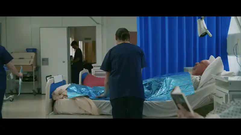 Group of presenters speaking on camera during a Microsoft live broadcast, filmed against branded event graphics.