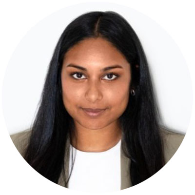 Close-up portrait of a freckled woman with soft pink hair and star earring, natural light, white tank top.