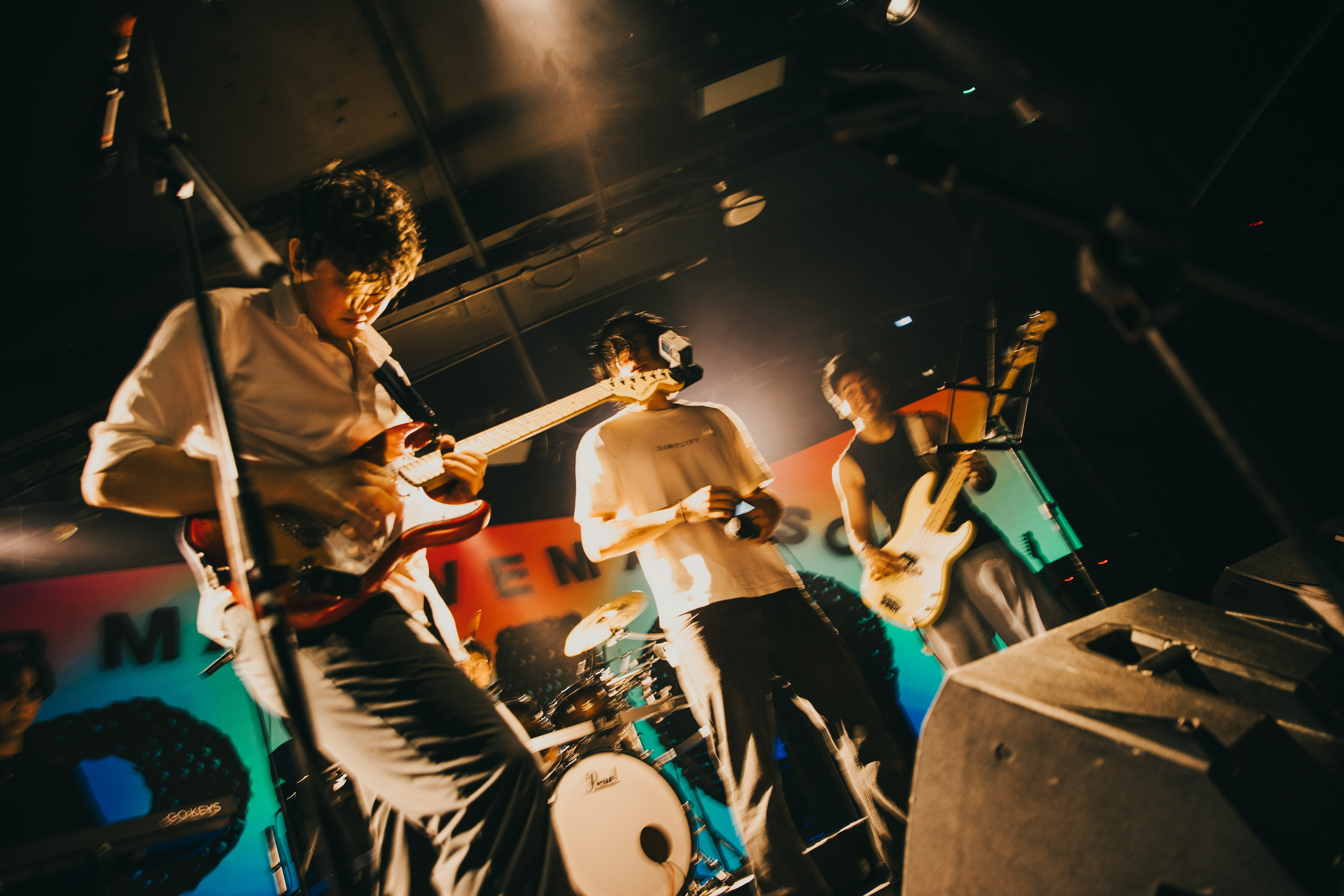 Student band performing on stage, drummer visible, under stage lights at Phil Studio.
