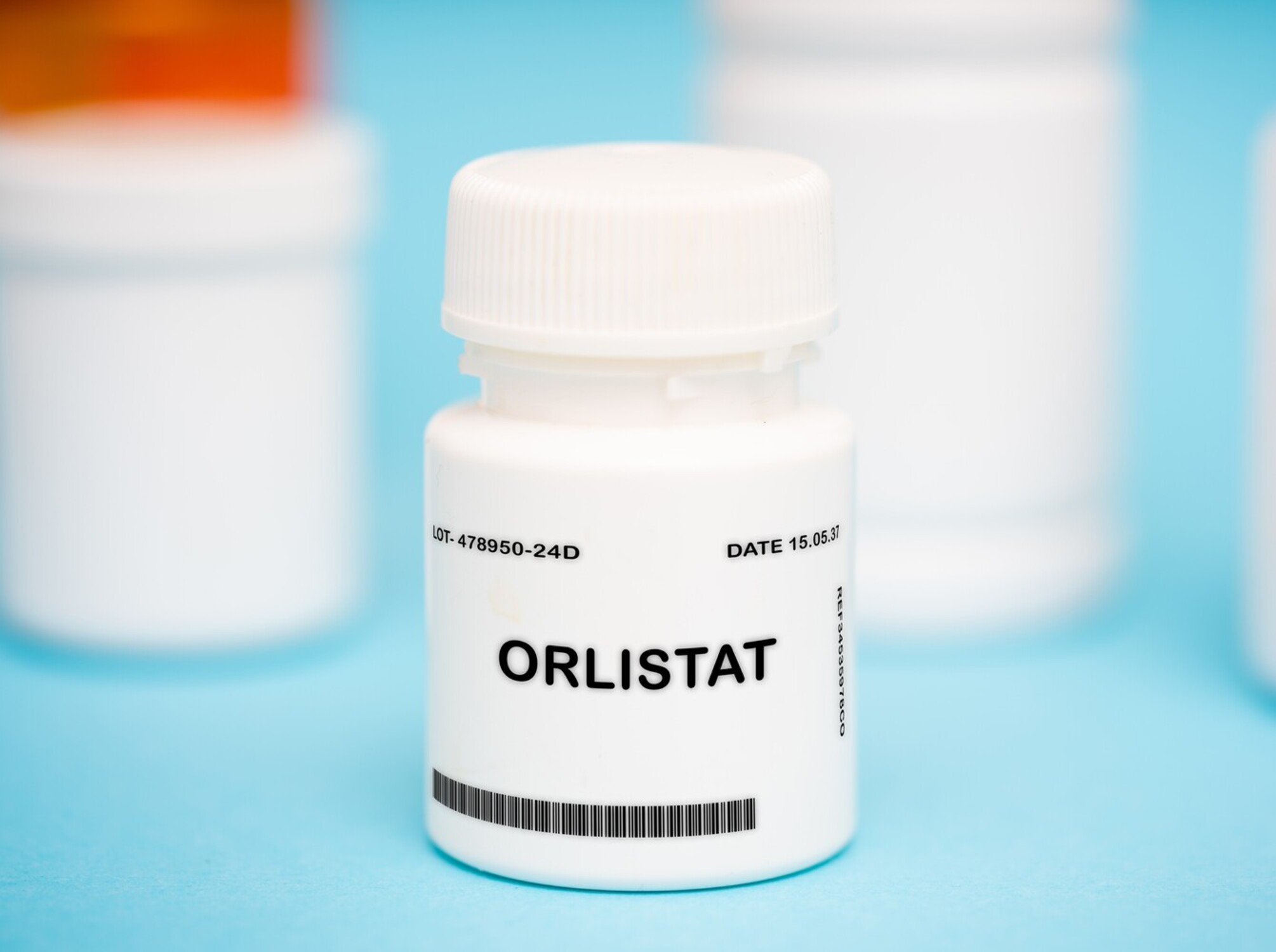 pill bottle with OTC weight loss pills inside