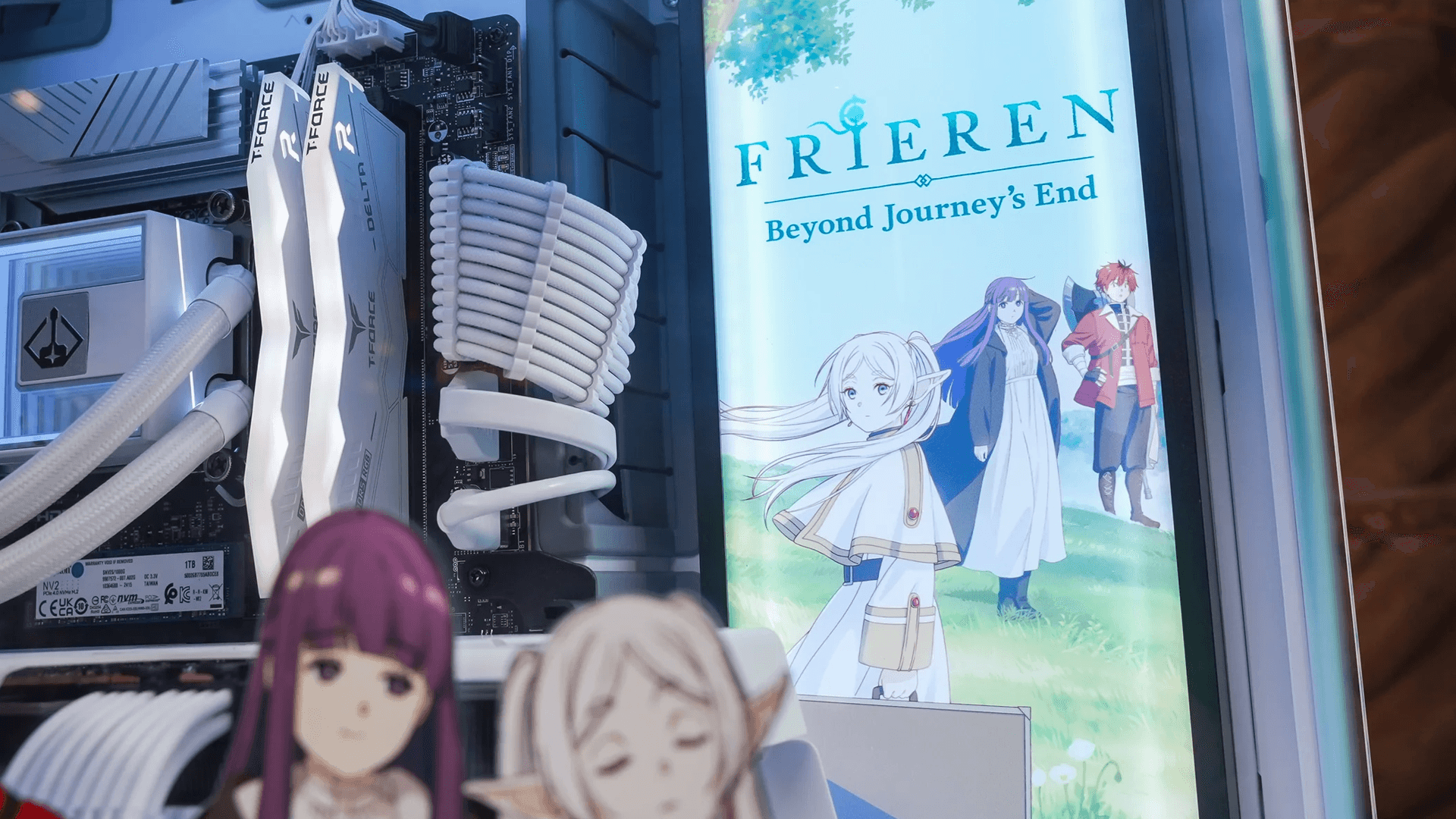 Two men discuss a project while standing at a laptop in an office.