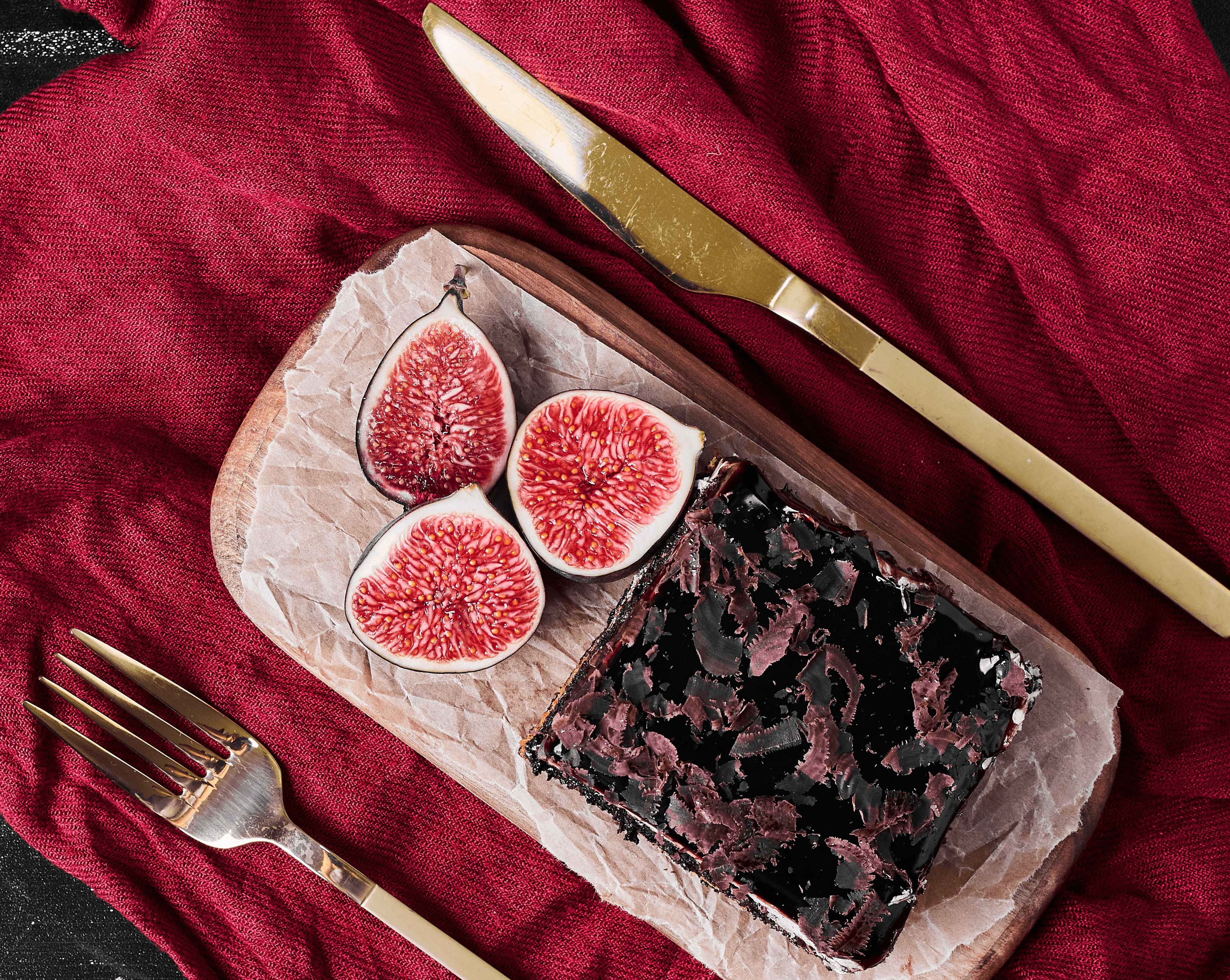 A modern black speaker illuminated by soft light, set against a green background.