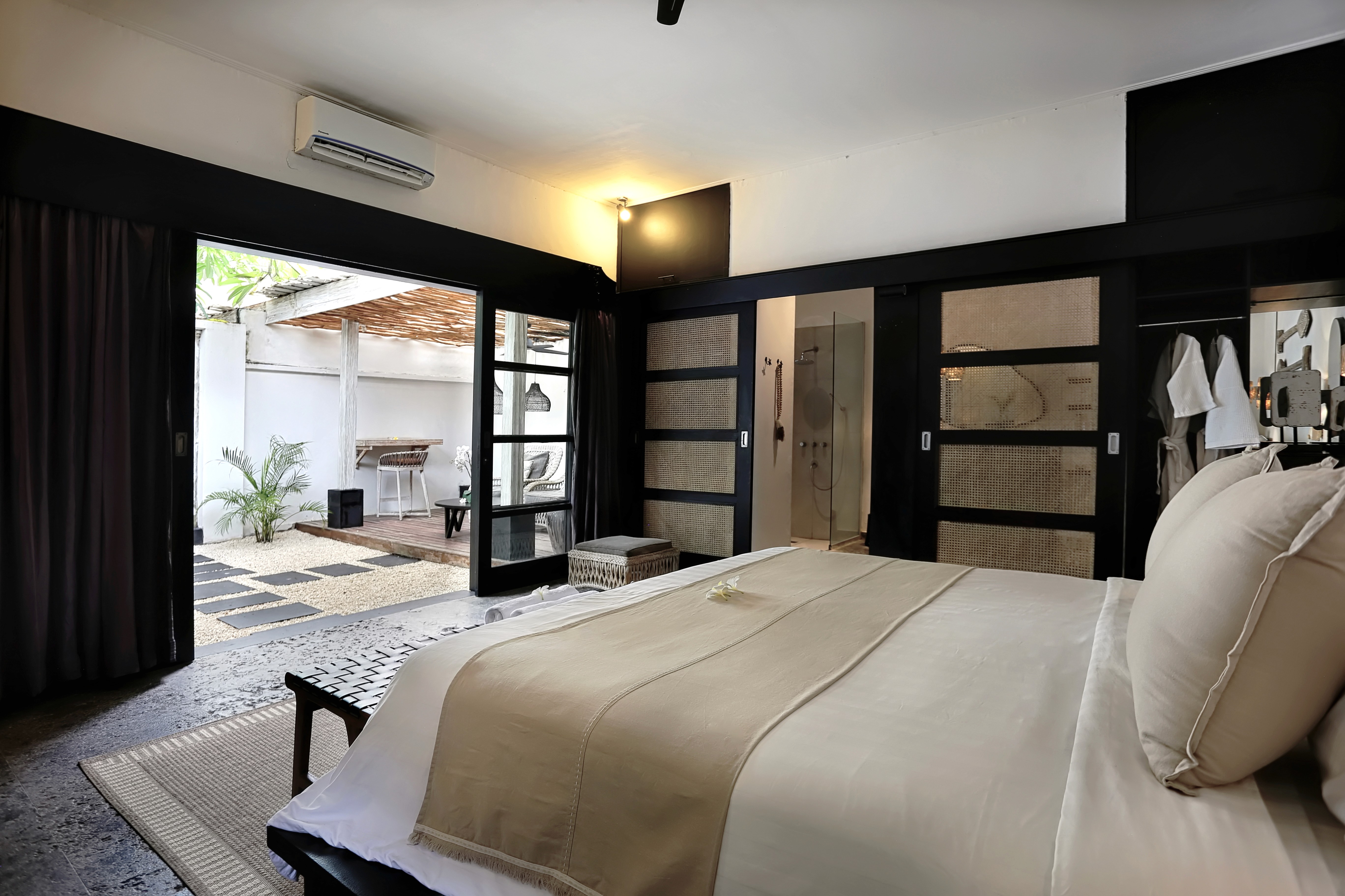 Garden view room with bed and terrace at Indiana Kenanga hotel, Nusa Lembongan Indonesia