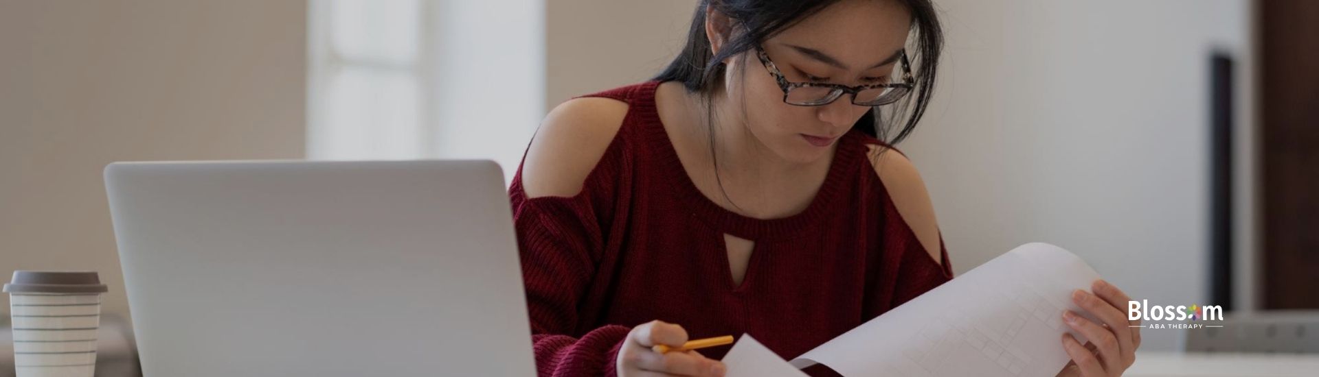 Woman studying for BCBA exam with laptop.