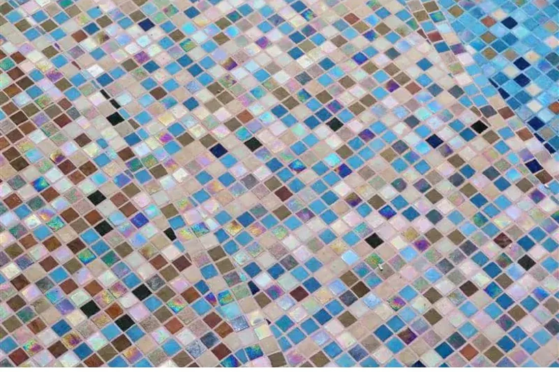 Close detail of an iridescent glass blend in blue, rose and bronze tesserae — Mosaiclegs Art Studio
