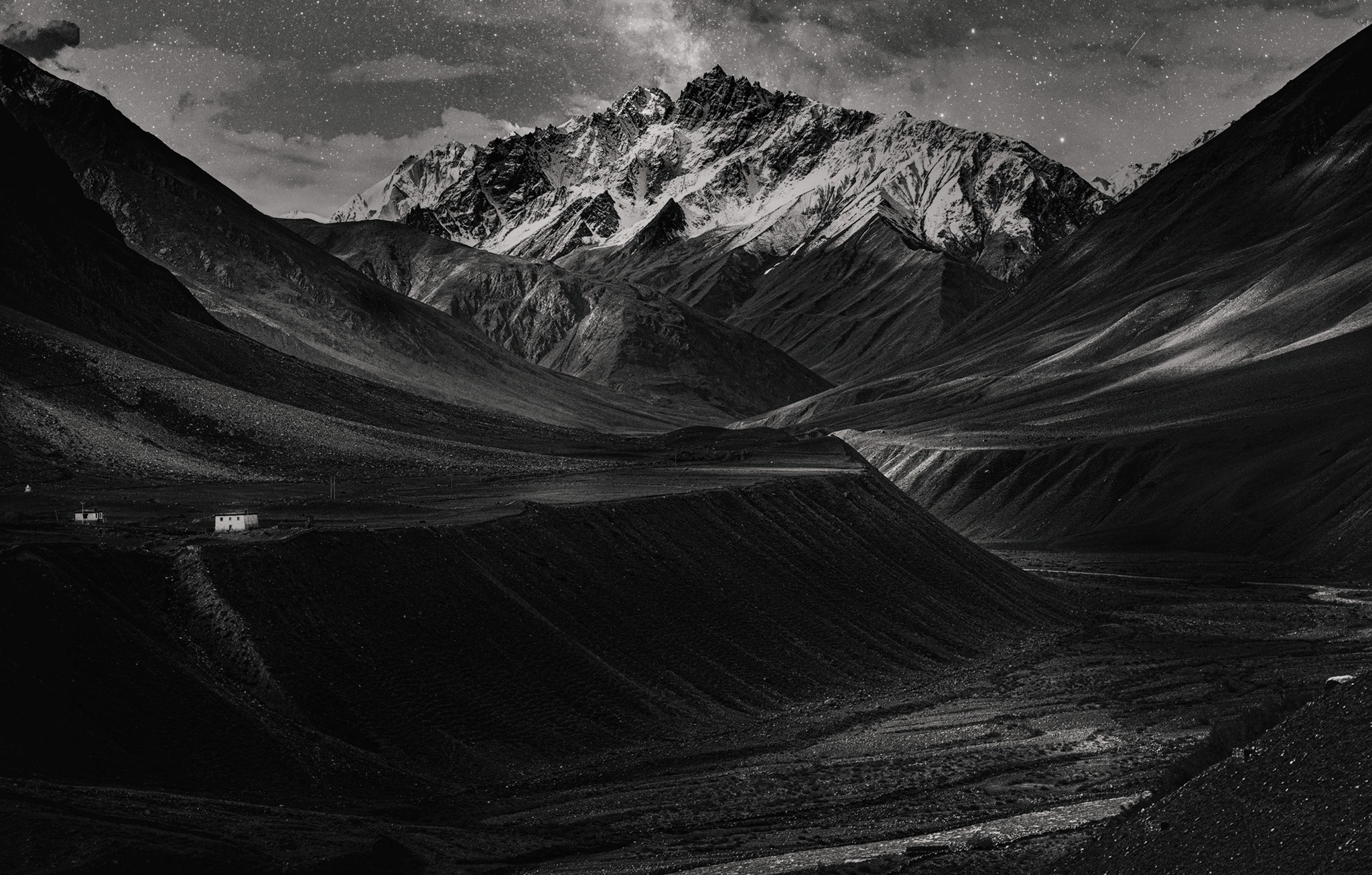 A bright white sky over sand dunes that stretch for miles