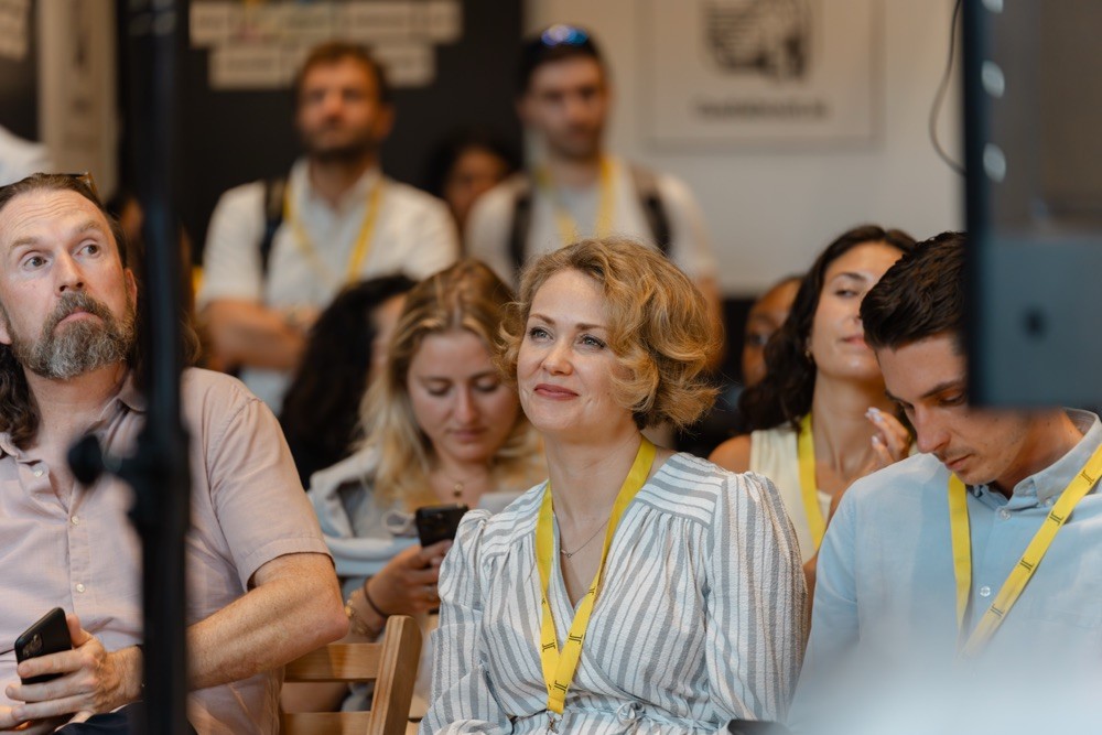 Audience member listening to a talk at Evolve 26 technology conference in Brighton
