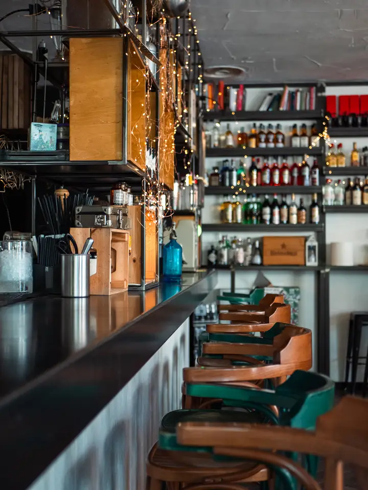 Portrait of a bartender pouring a cocktail
