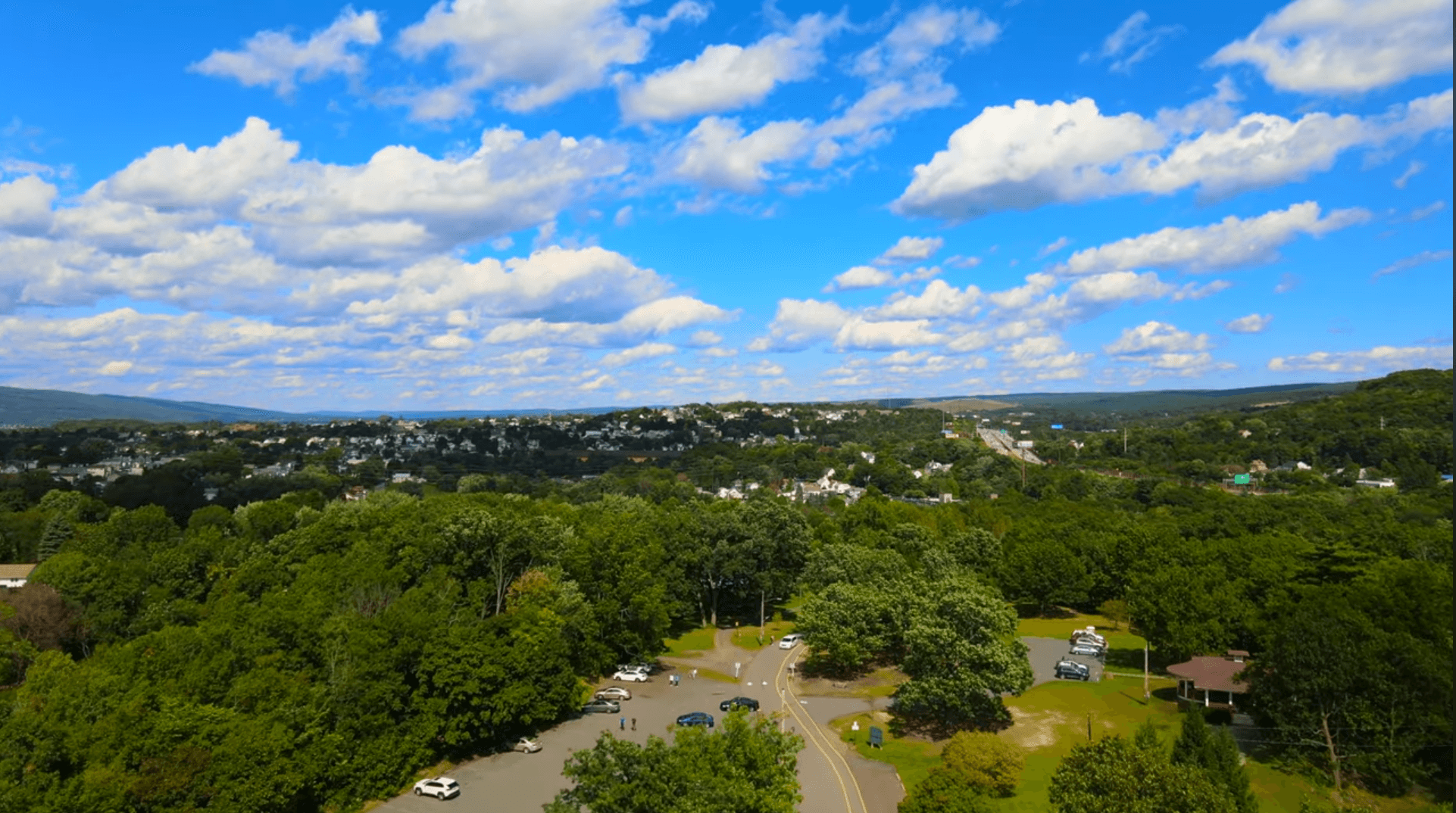 A fast black sports car races down the highway.