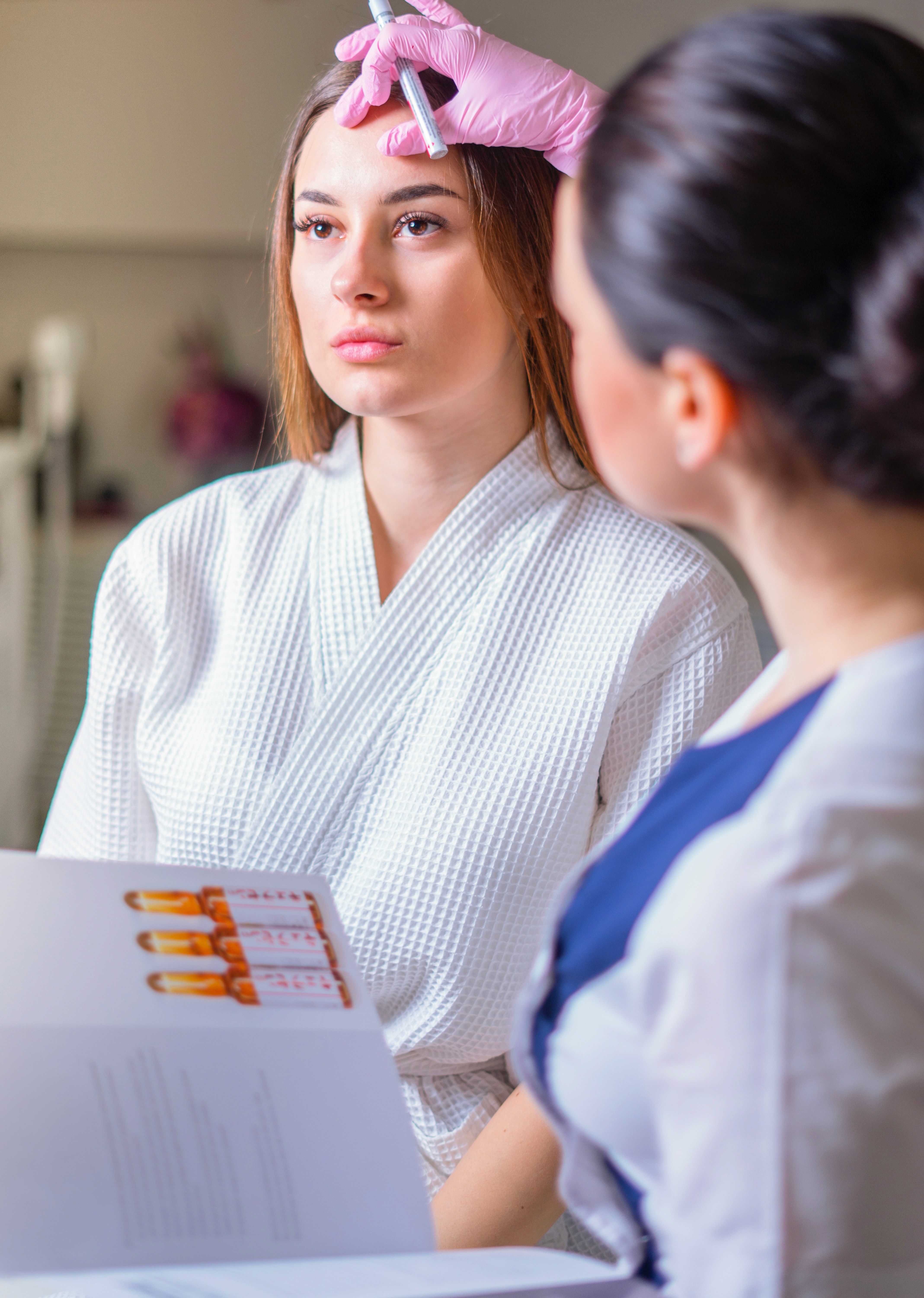 client in aesthetic clinic looking at results