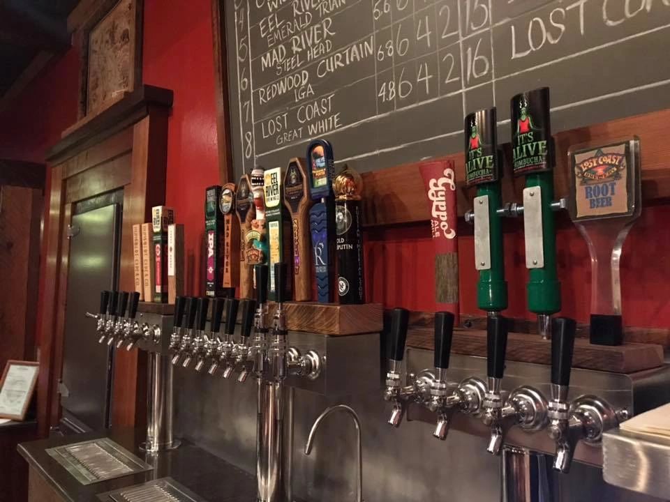 Craft beer taps and a chalkboard inside Redwood Palace in Miranda.