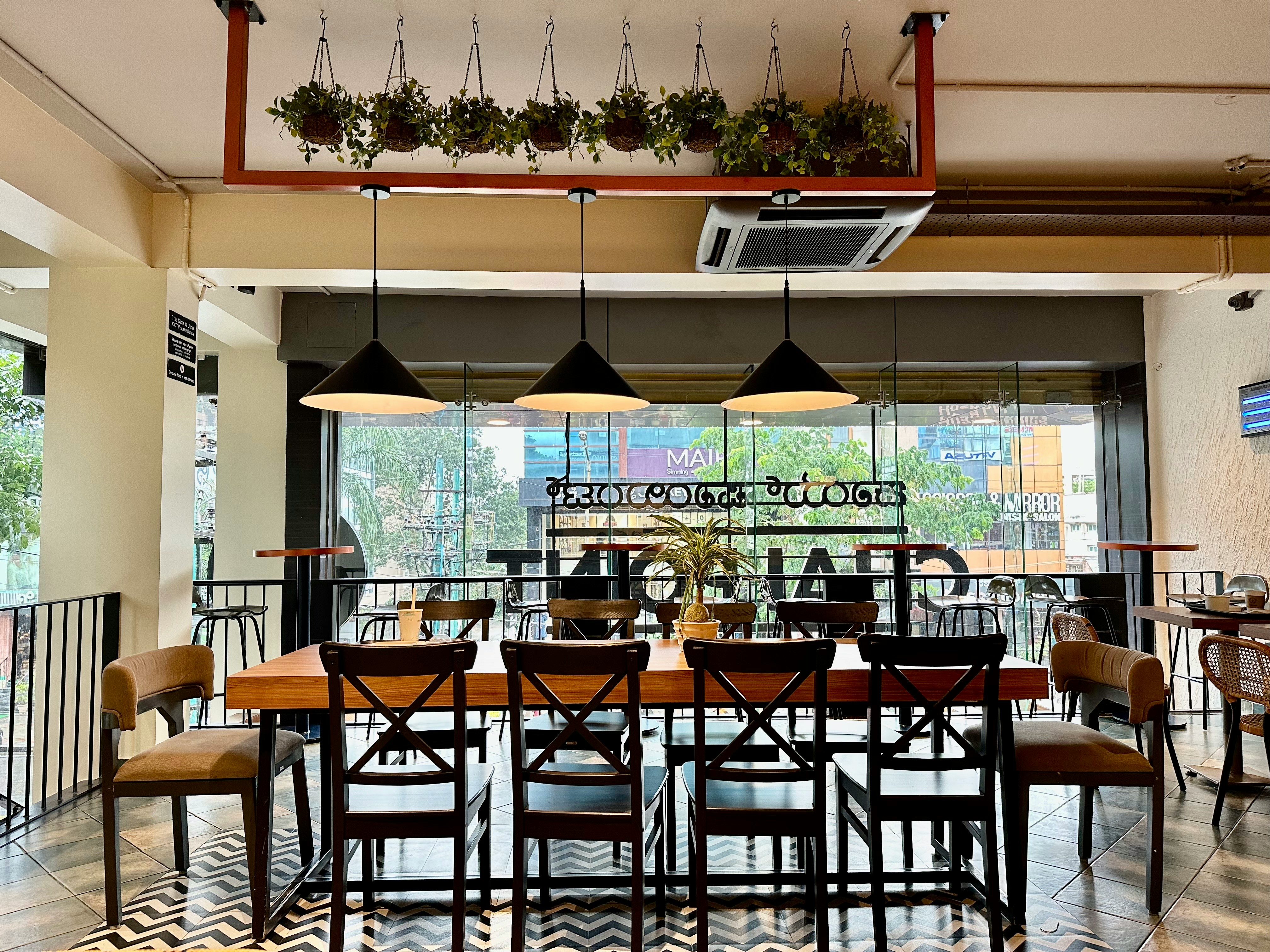 a restaurant with a large table and chairs