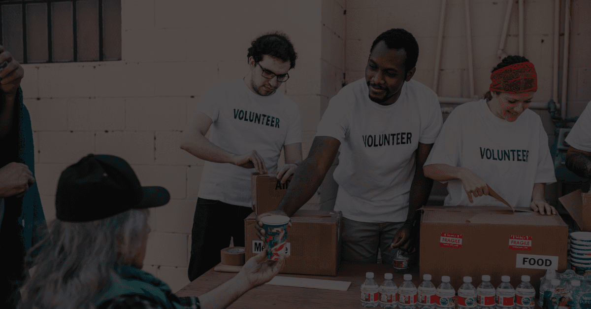 Three volunteers helping pass out supplies