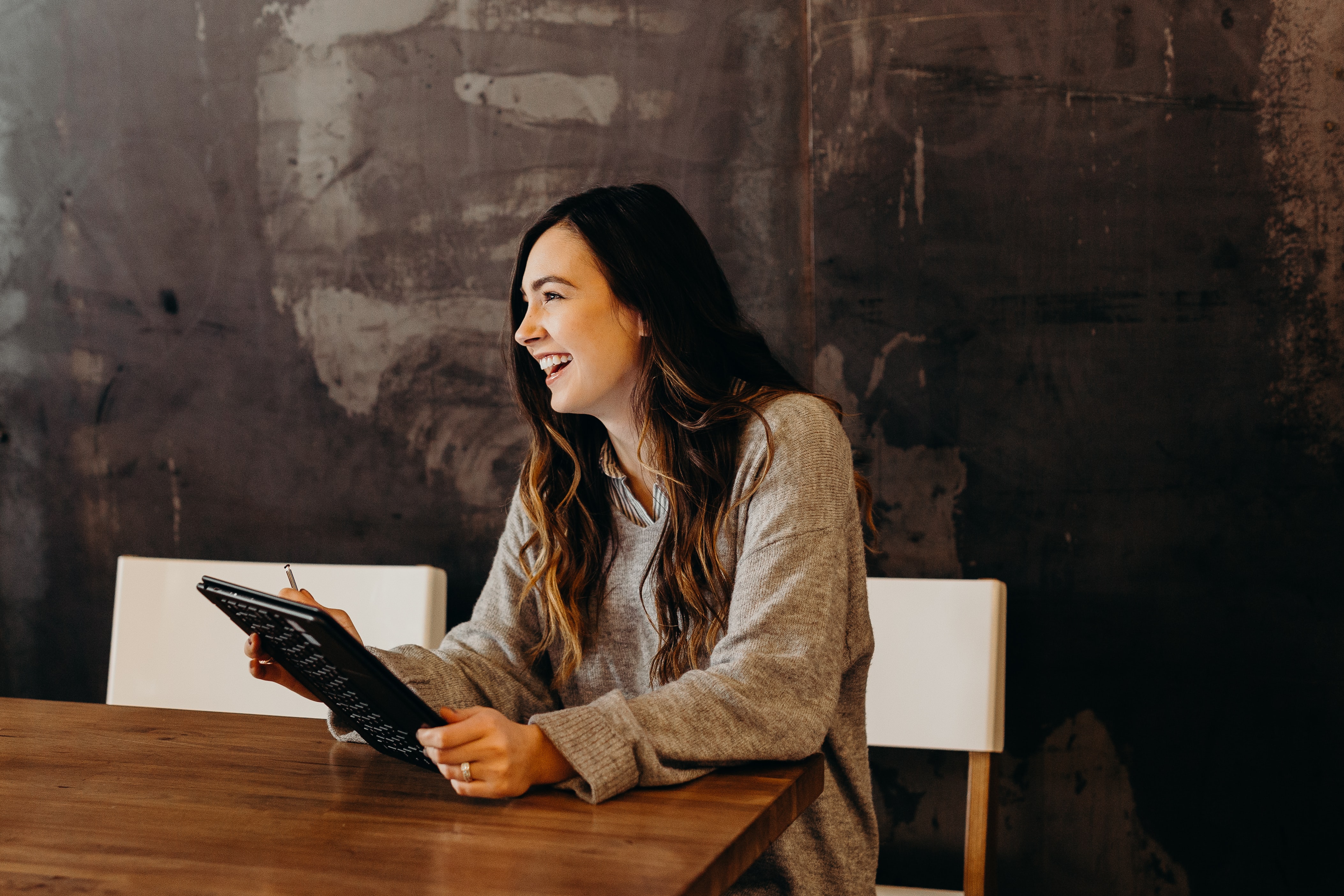 Woman laughing at table