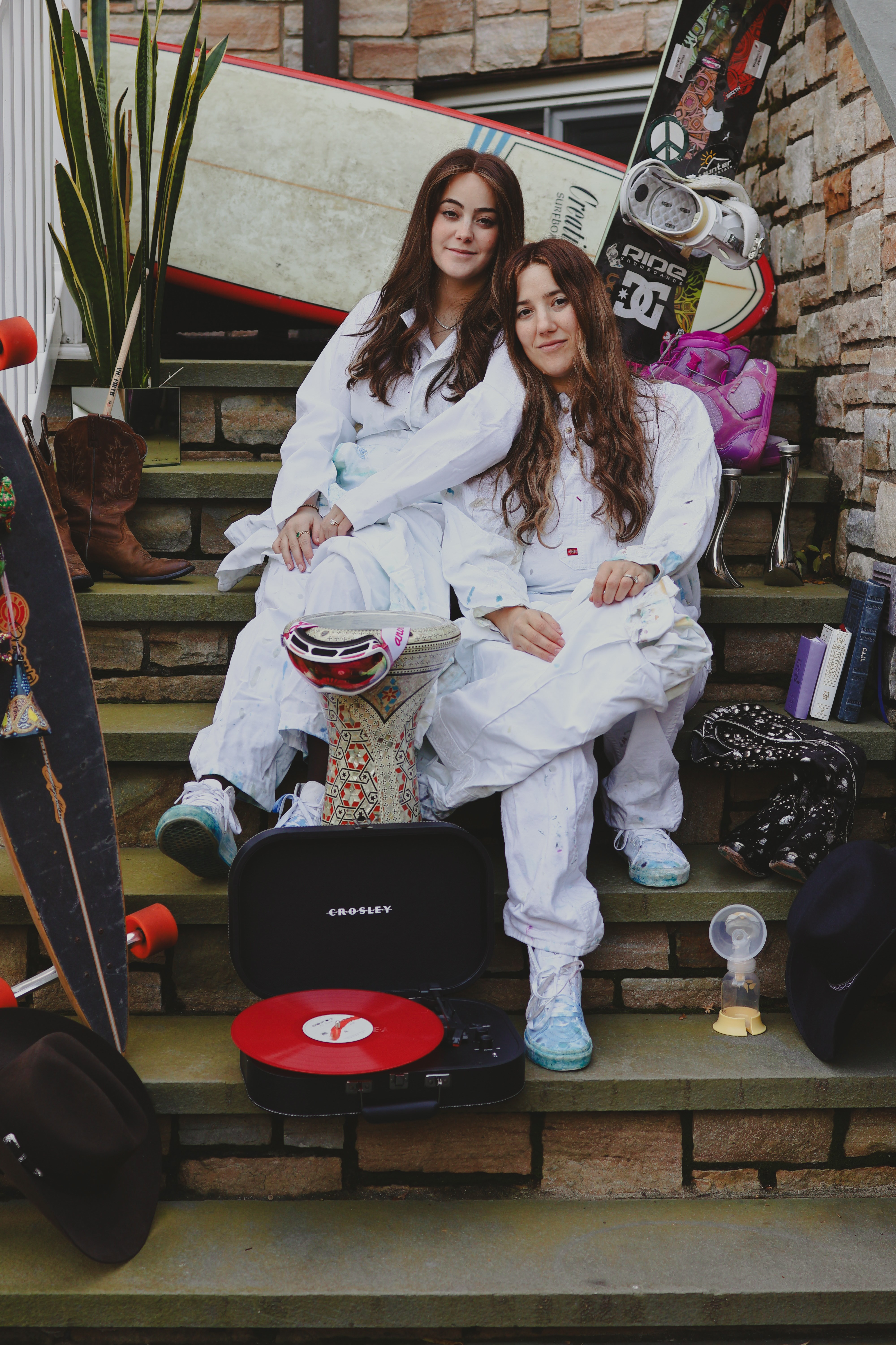 A woman observes framed black-and-white photographs in warm golden light