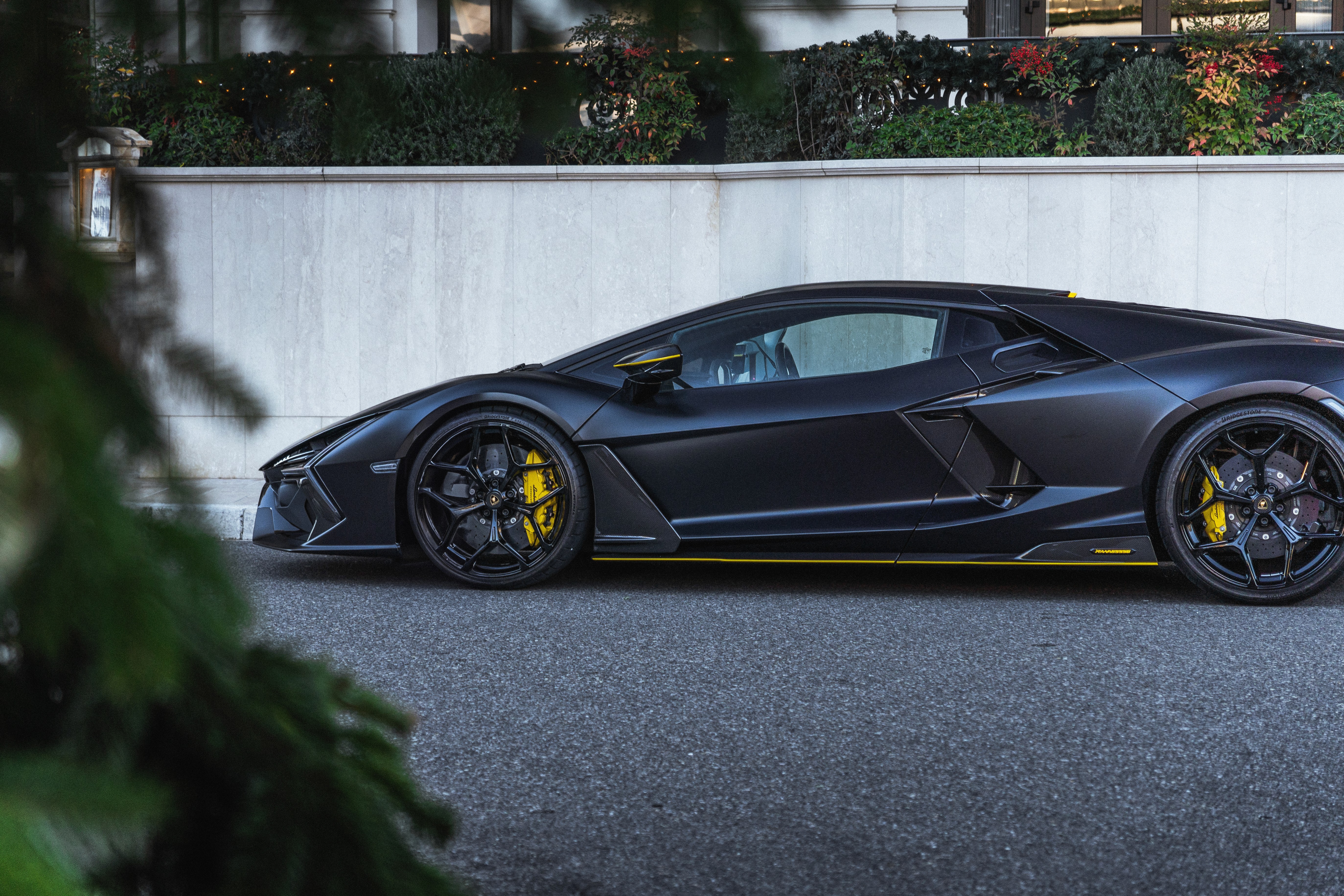 Fashion model wearing white sunglasses and a royal blue top, showcasing sleek hairstyle.