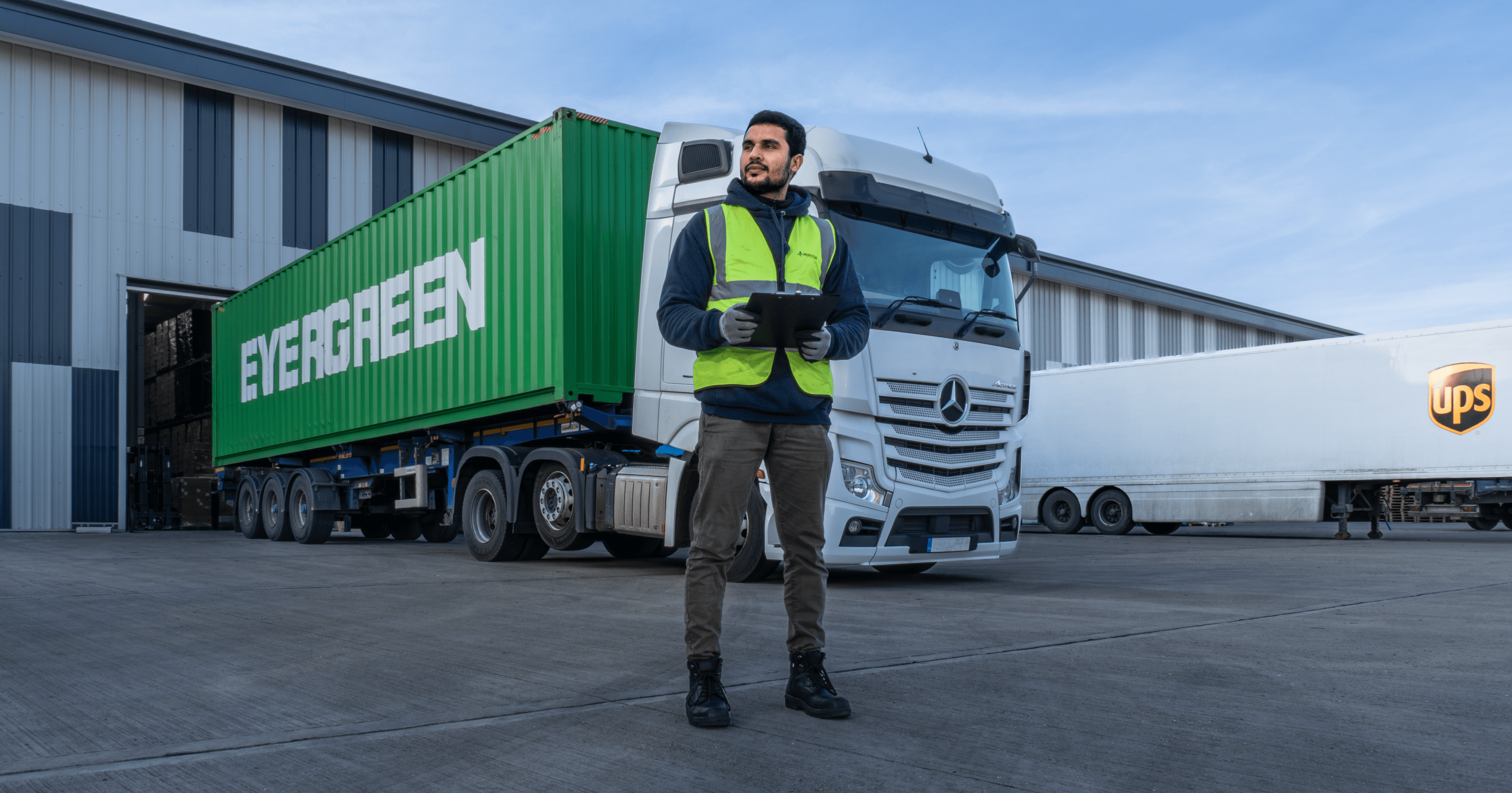 worker-standing-in-front-of-a-truck