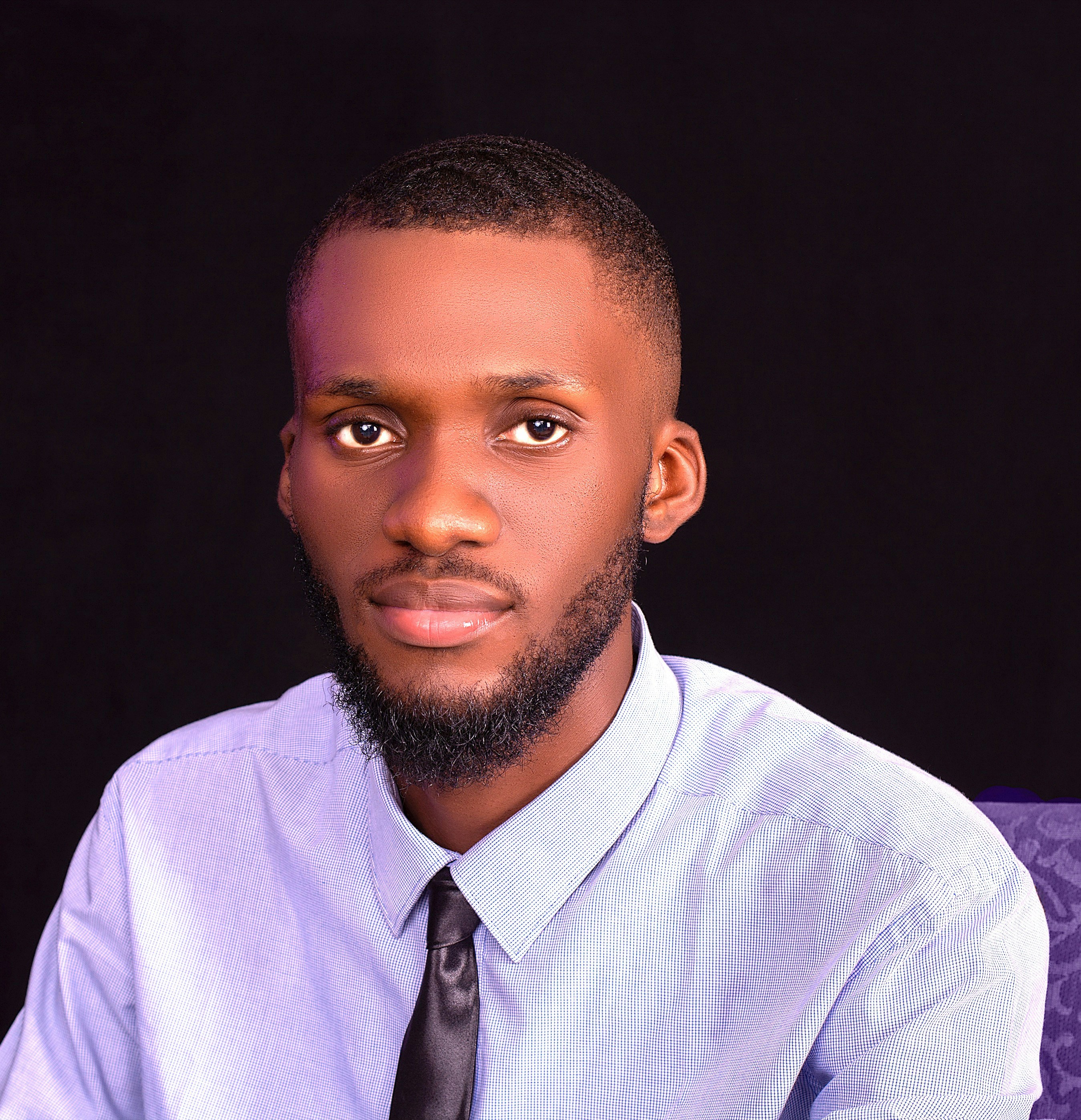 A young man with a beard and tie