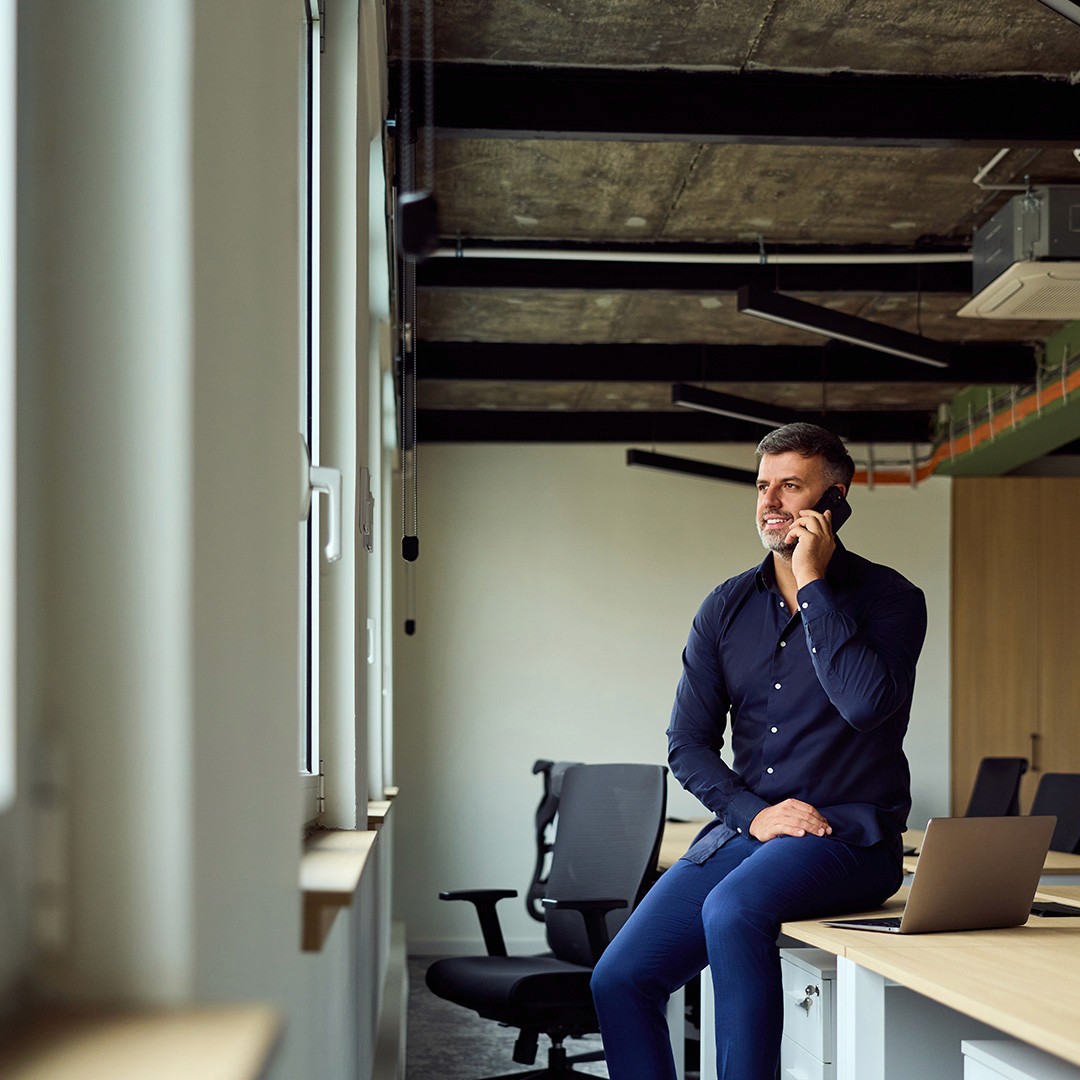 Image of security professional taking an international security phonecall in a London office