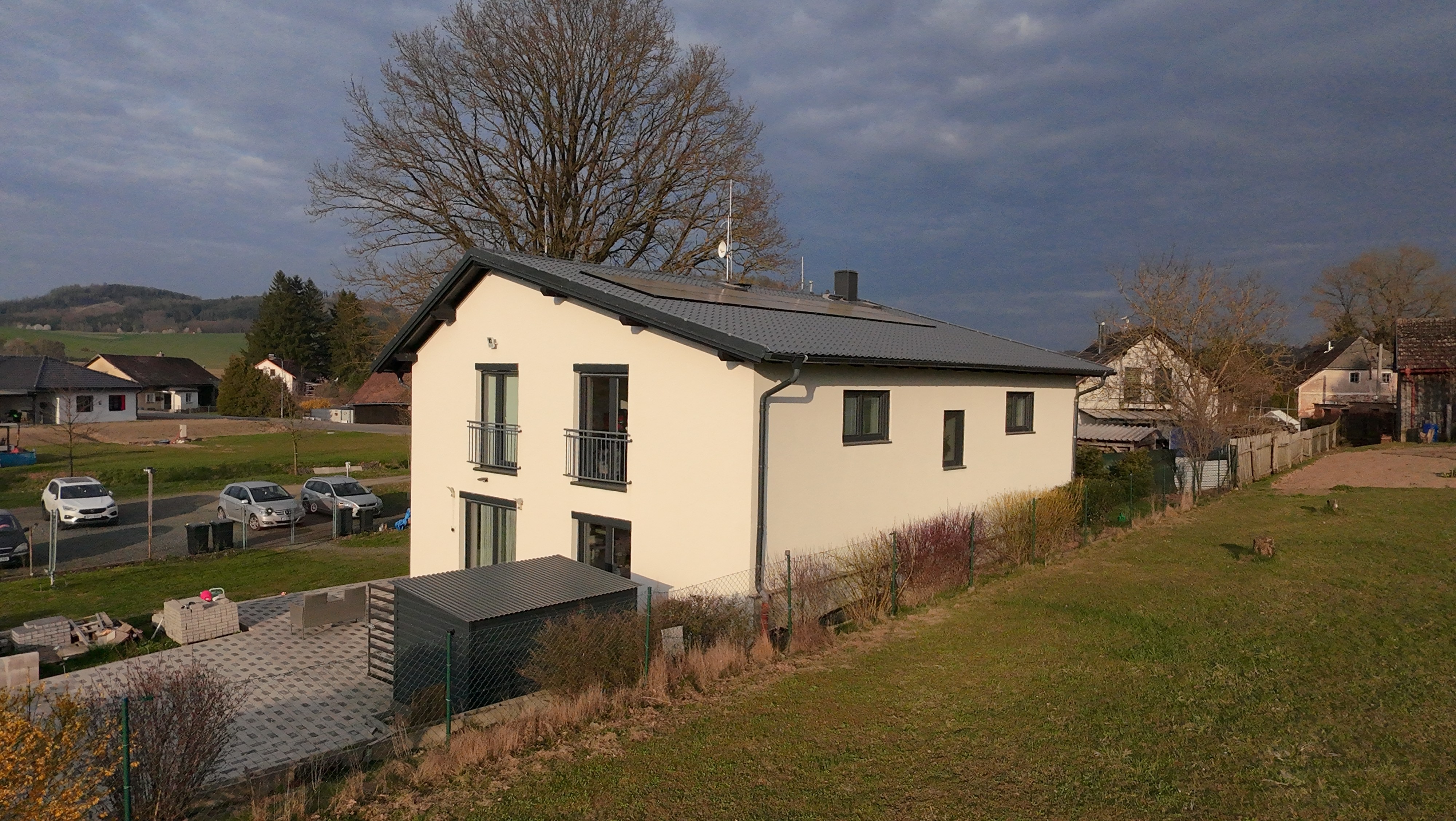 Woman in beige sweater sitting at table checking smartphone
