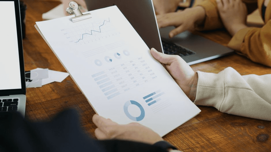 A team looking at a CRM pipeline dashboard during a sales and marketing review.