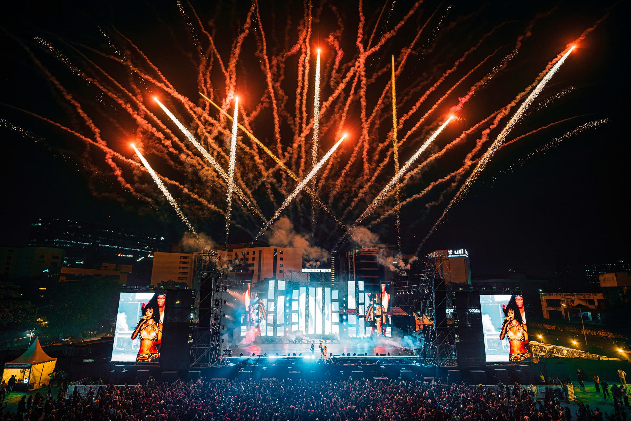 Fireworks over a concert stage at night. Festive celebration.