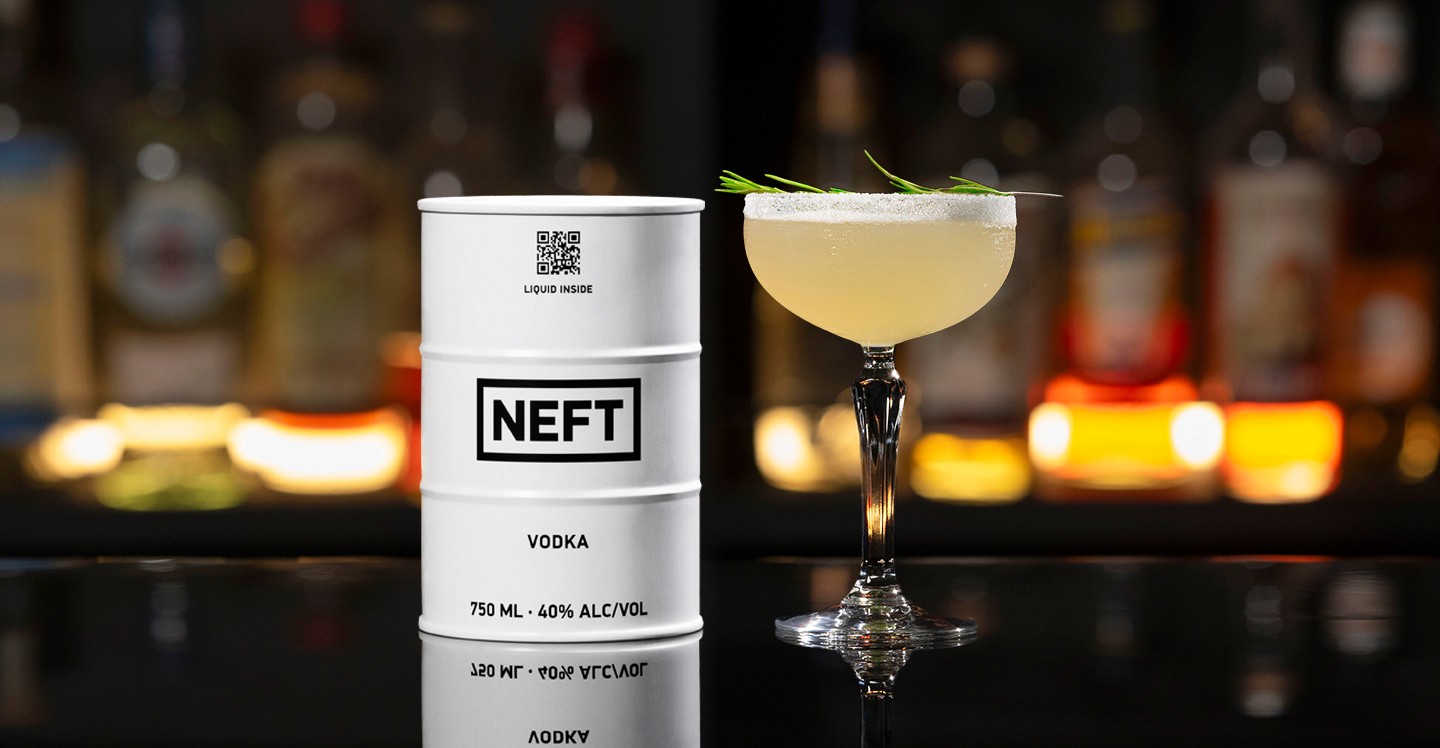 A NEFT Barrel and a glass of Nellie Bly on a bar counter.