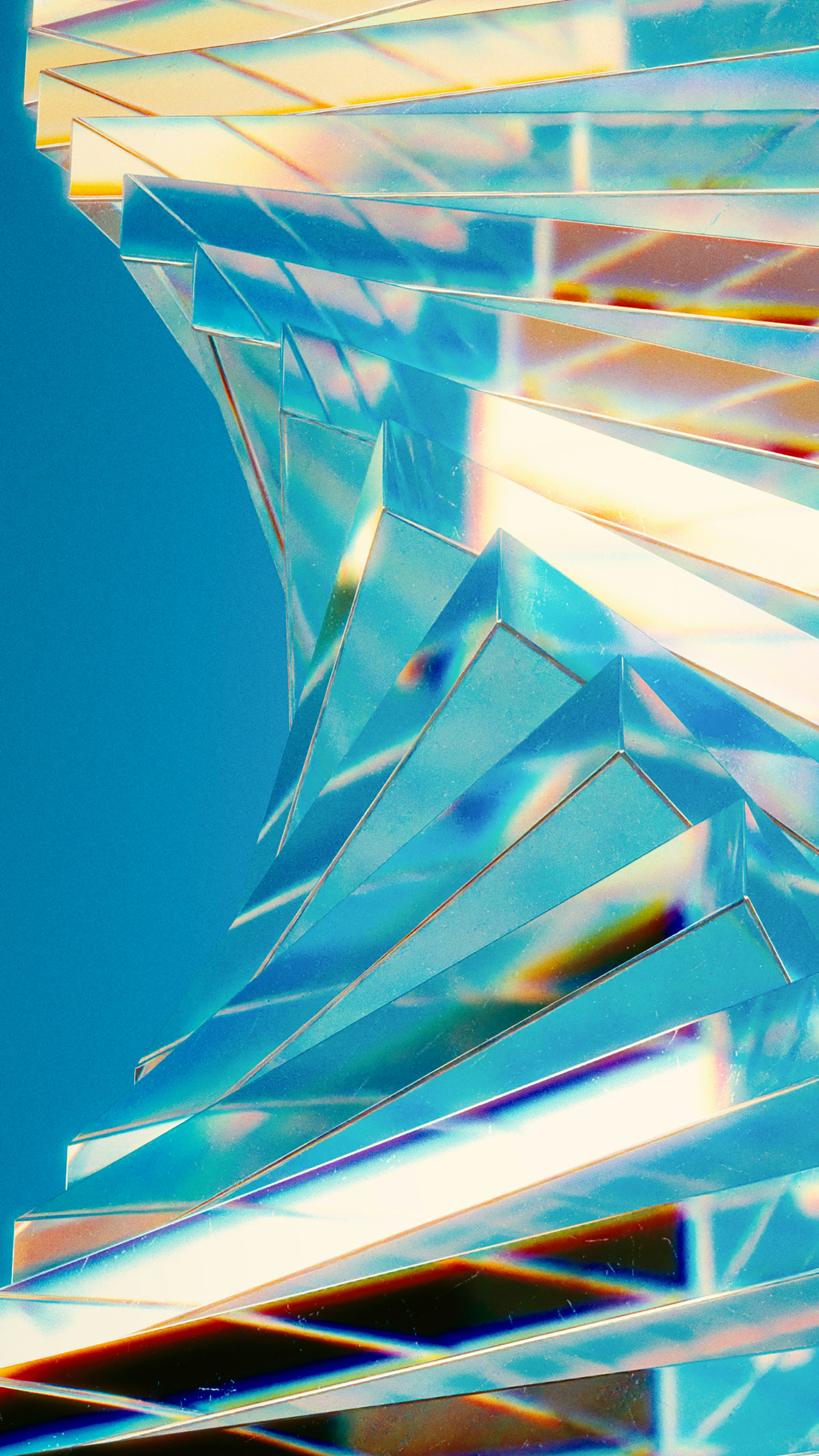 Iridescent spiral with colorful light reflections on blue.