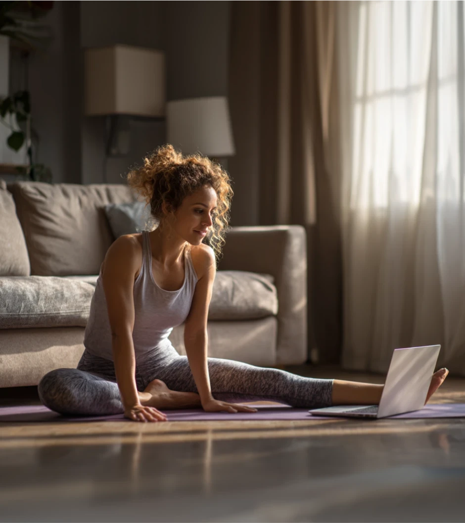 Woman stretching in her living room on a yoga mat