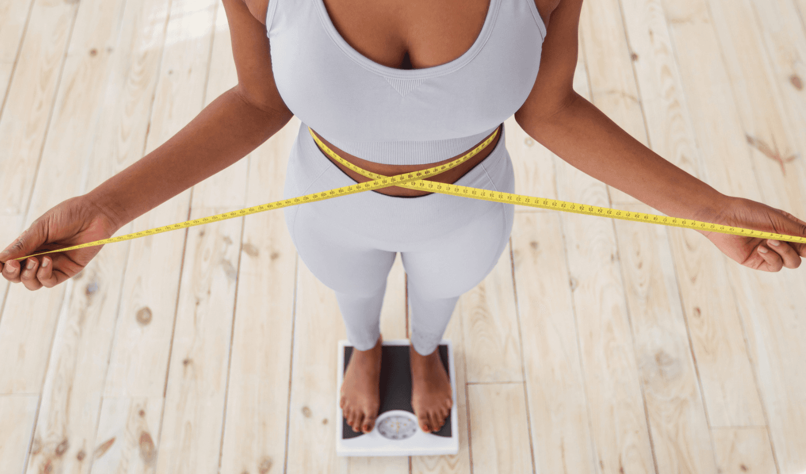 woman checking weight - Does Nutrafol Help With Weight Loss 