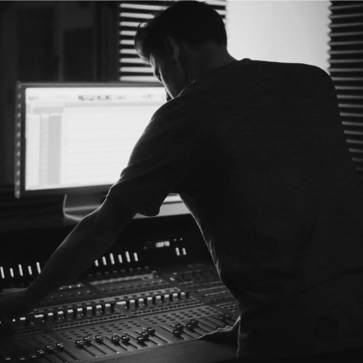 A talented mixing engineer is working with an audio interface, an equalizer, and an audio mixer.