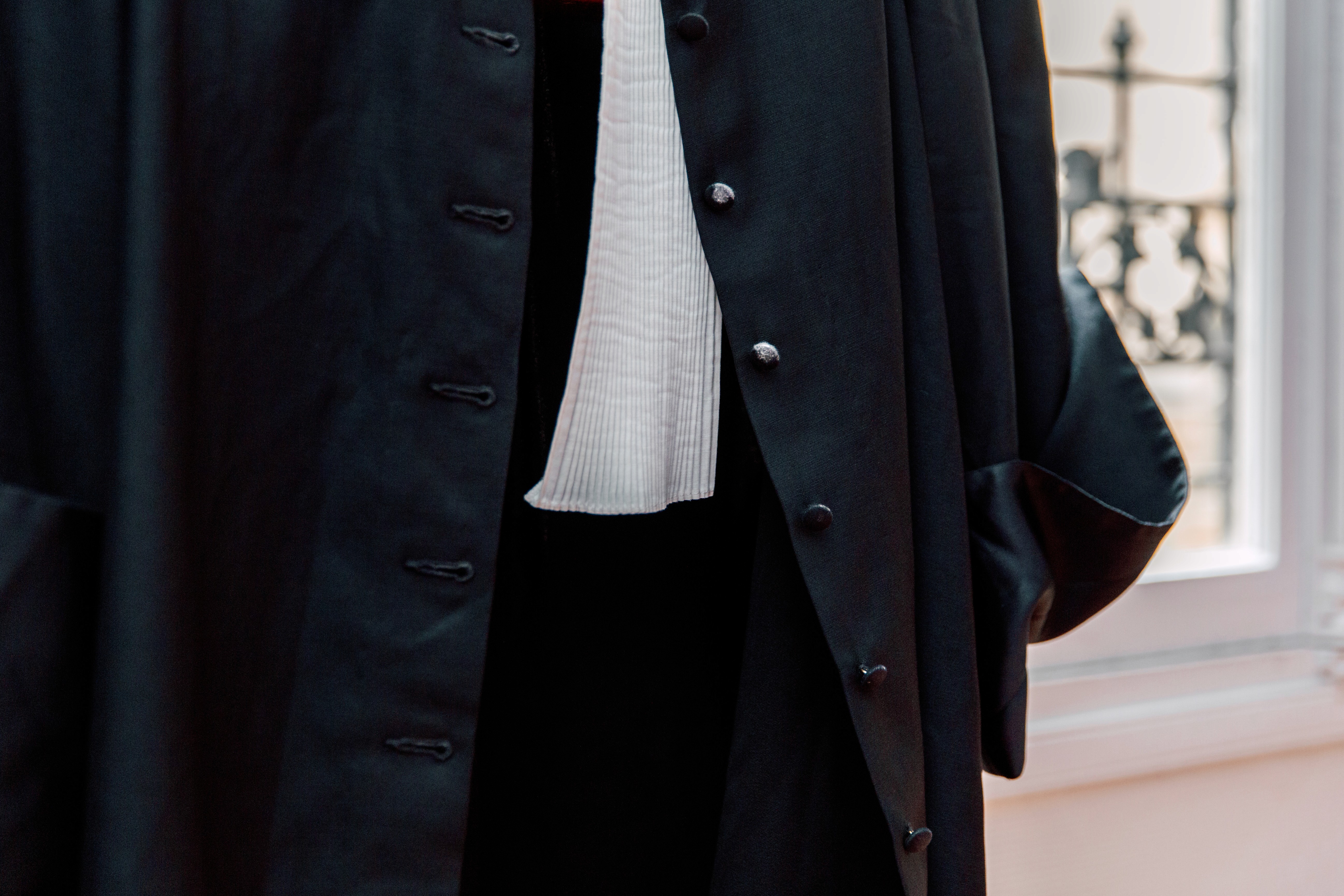 a woman wearing a black coat and a white scarf
