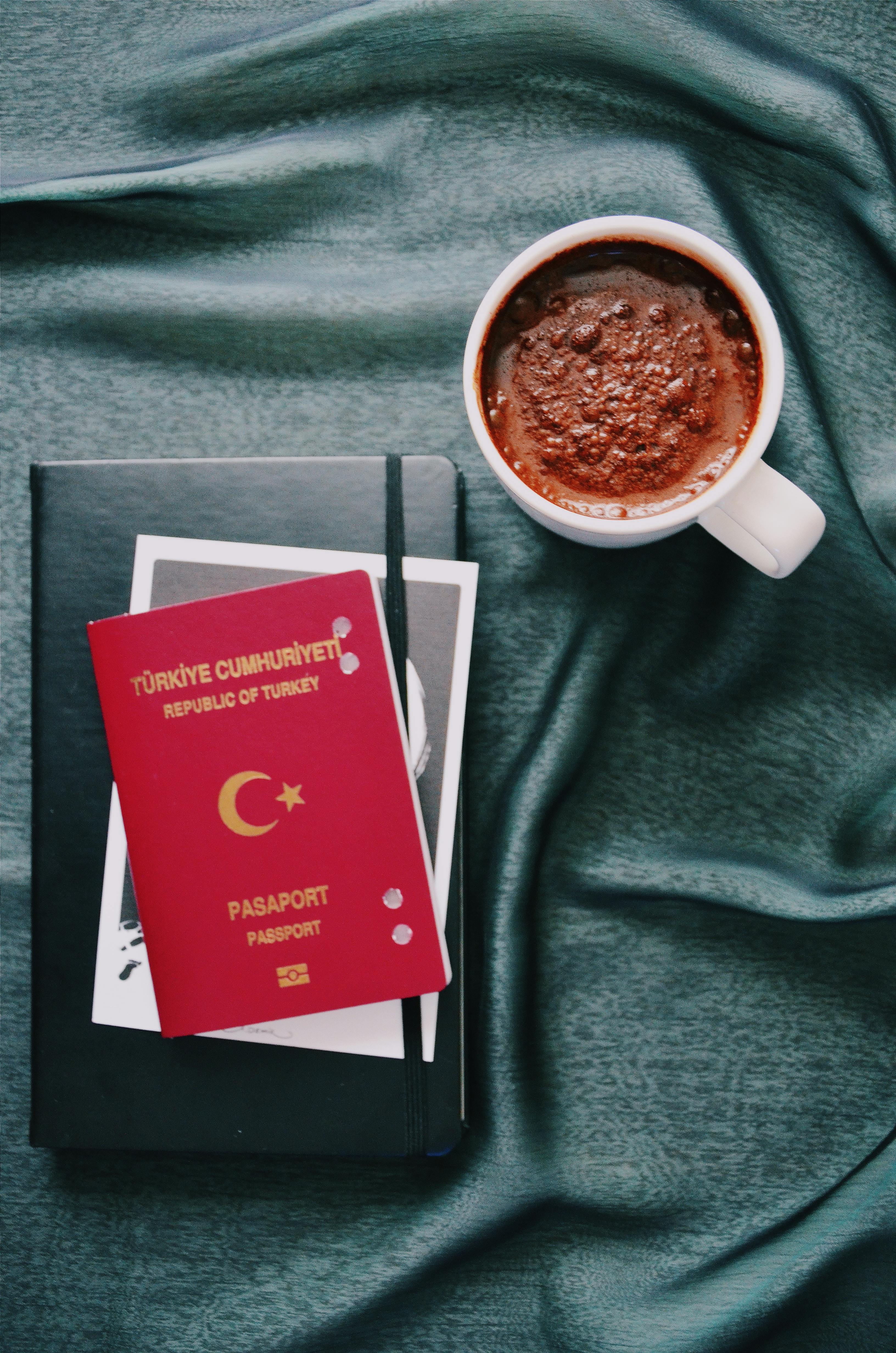 turkish-passport-and-coffee-cup-on-elegant-blue-fabric,-ideal-for-travel-themes. - gül-işık (pexels)