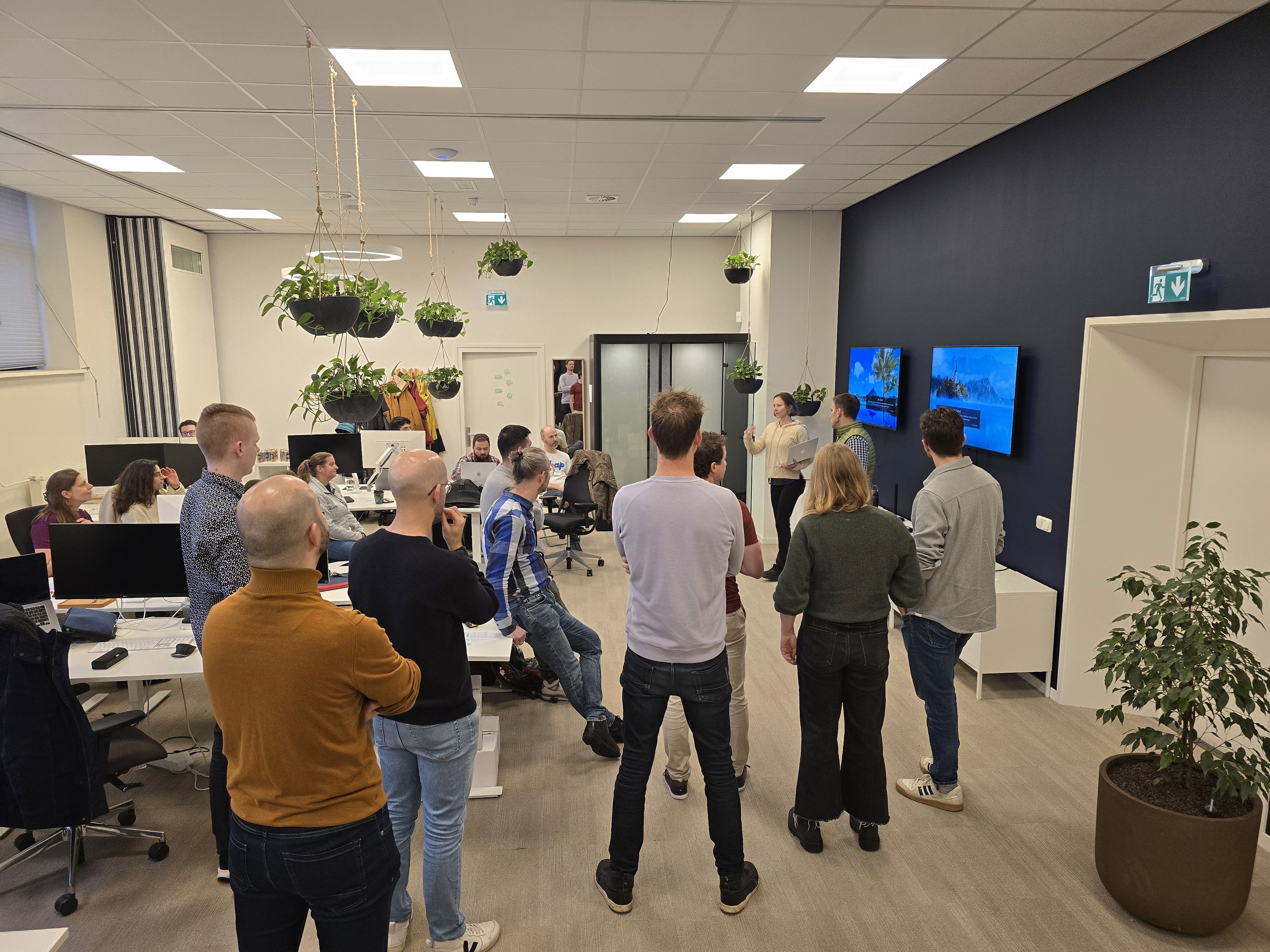 A group shot of the Leap team watching a presentation in an office