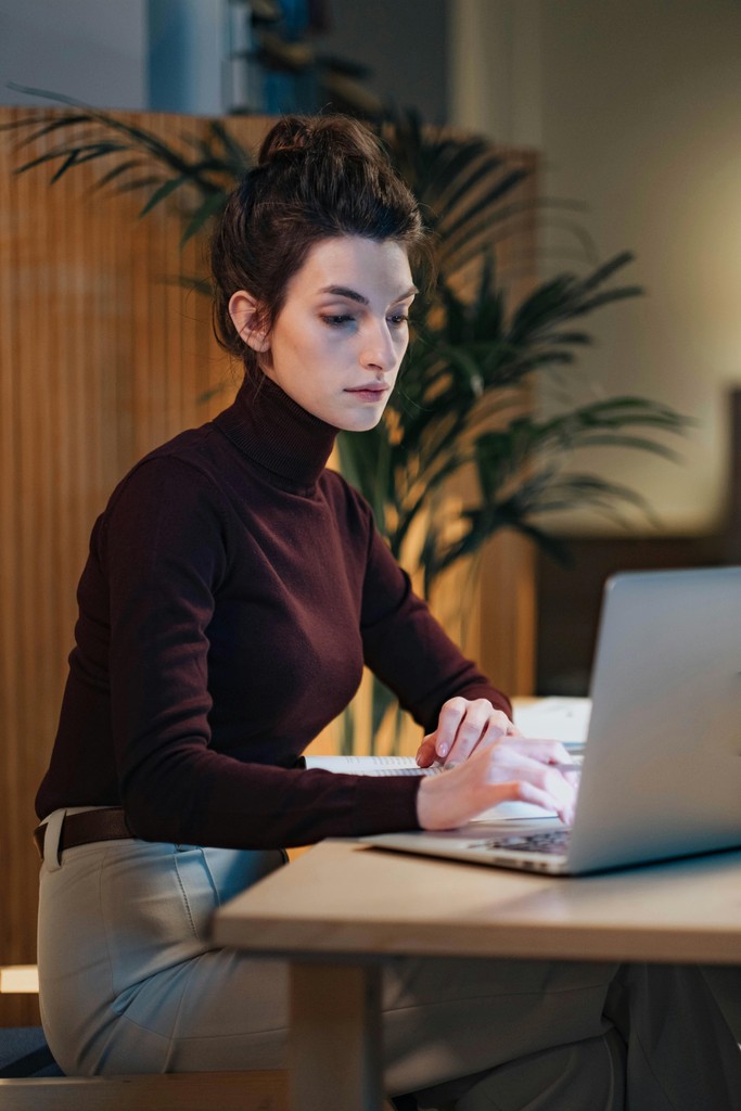 Sales lead reviewing a property tour on a laptop by a window