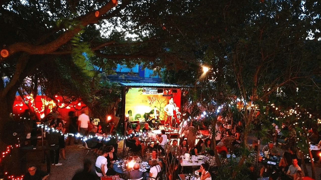Crowd of people enjoying local music at Bacchanal in the Bywater in New Orleans