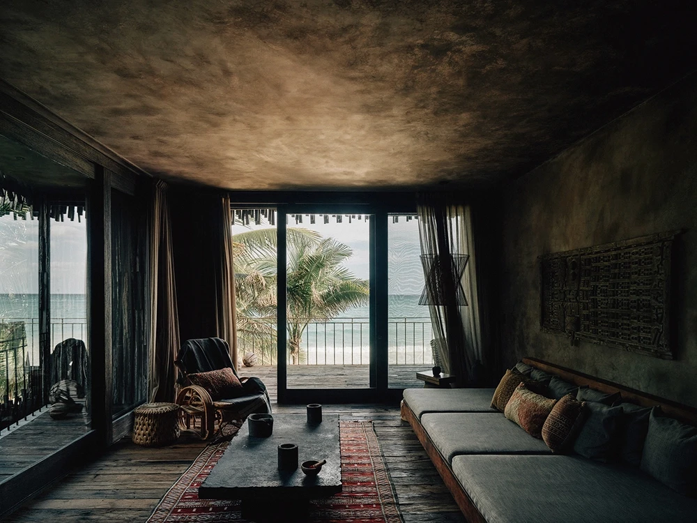 Premier Suite at Nômade Tulum featuring majestic private pool scene with ocean view and beautiful palm trees, all seen from the private terrace.