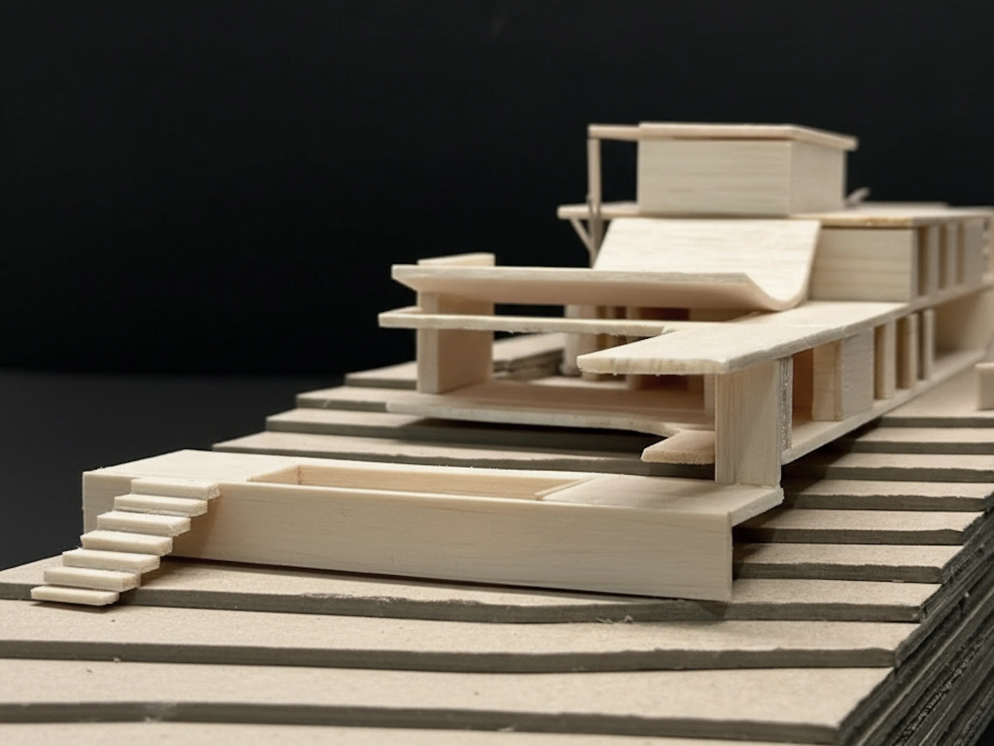 Close-up of stepped wooden architectural massing model with pool.